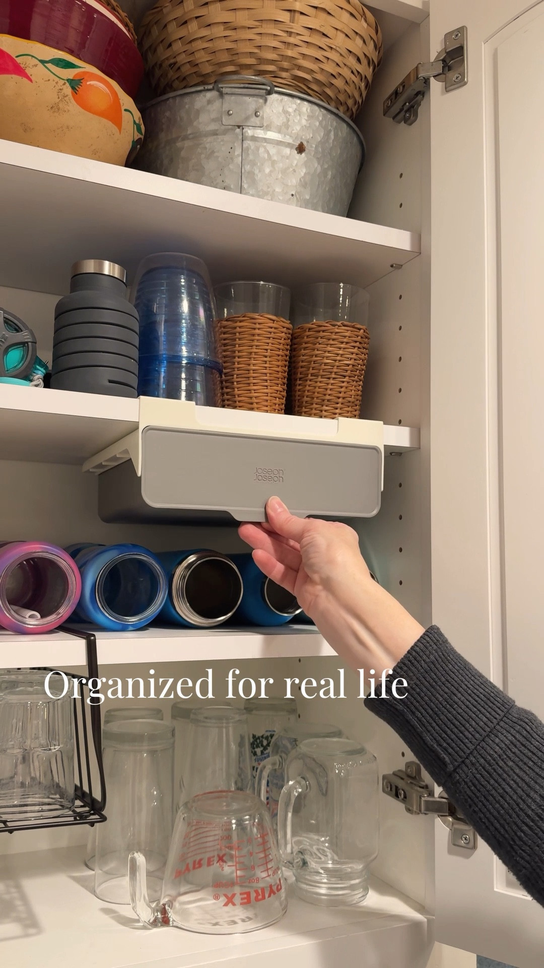 Adhesive under-shelf drawer for small cabinet items.

I use this for water bottle caps and straws so they’re not loose in the cabinet. It hooks underneath an existing shelf and adds hidden storage for smaller items.

Simple install. Great for maximizing unused vertical space.
 
🏠 I share real-life decor, home finds, and organization for spaces that are pretty, not perfect. 💫

#LTKHome #LTKmomlife