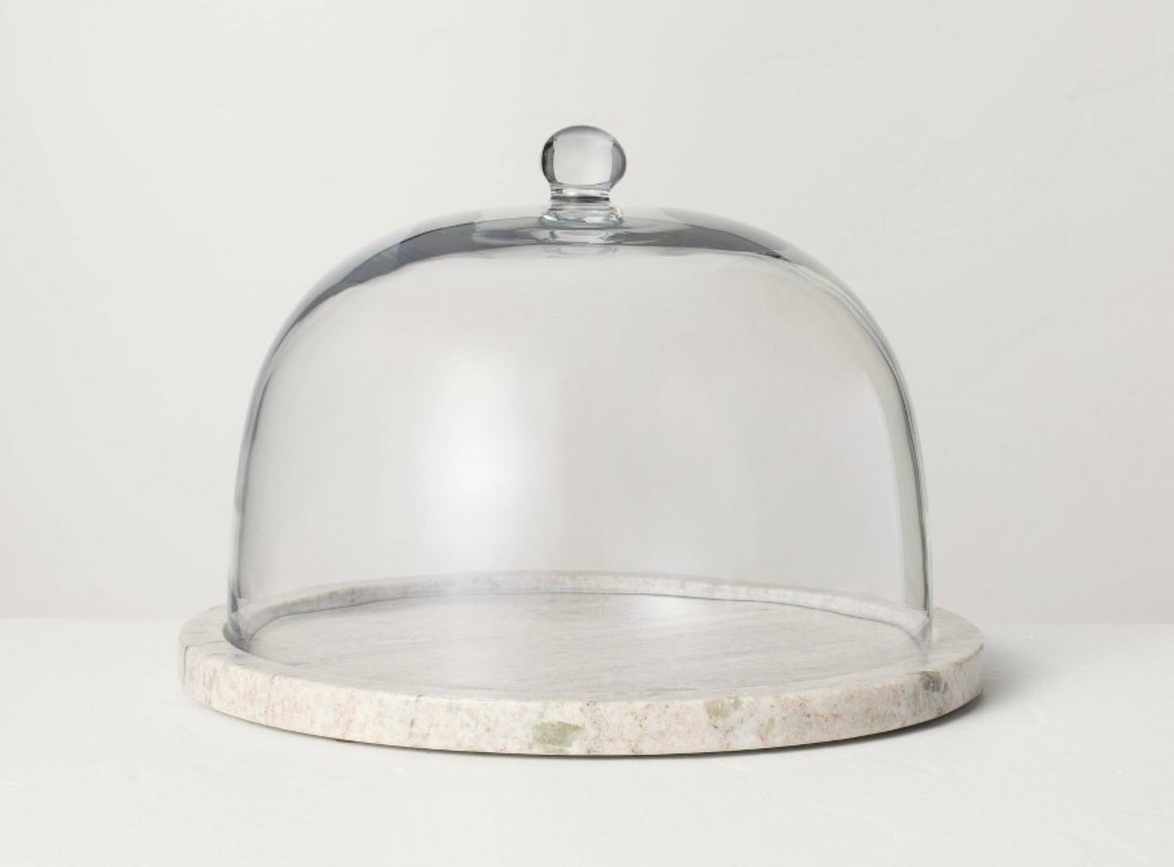 Marble Covered Dessert Stand from Hearth & Hand™ with Magnolia. Designed in a warm gray hue, this dessert stand features a round shape with a pedestal base, making it great for serving cakes, pies and other desserts.

#LTKFindsUnder50 #LTKHome #LTKSeasonal