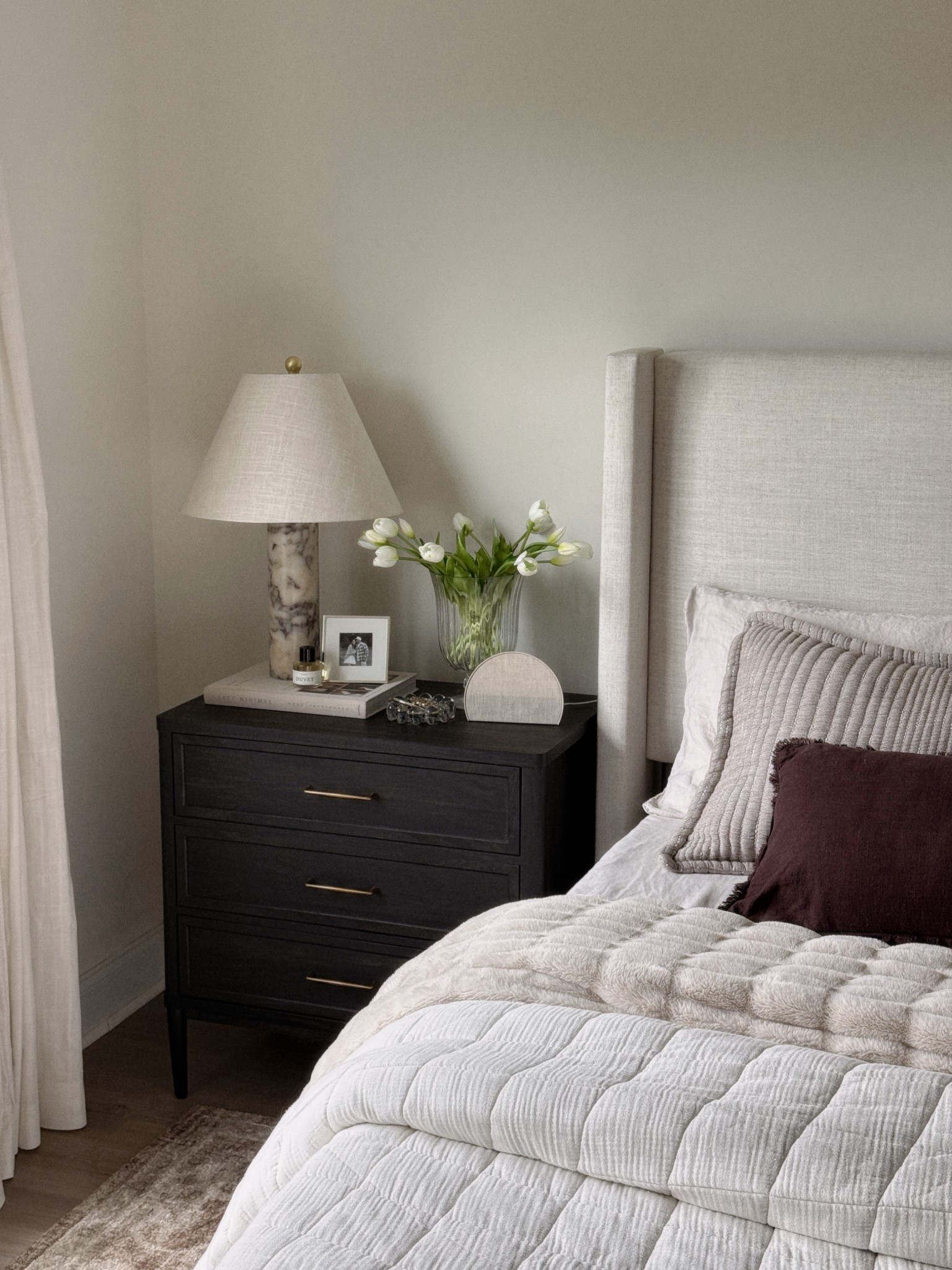 Bedroom inspo. Neutral bedroom. Black nightstand decor. Spring faux flowers. Spring stems. Loloi rug. Quince bedding. Upholstered bed framee

#LTKHome