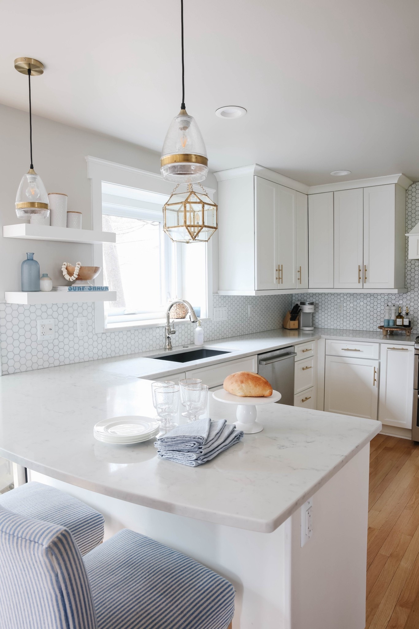 This white coastal kitchen is light, bright and airy! The brass pendant light adds the perfect touch to the whole space! 
#LTKFindsUnder50 



#LTKvlog #LTKHome #LTKOver40