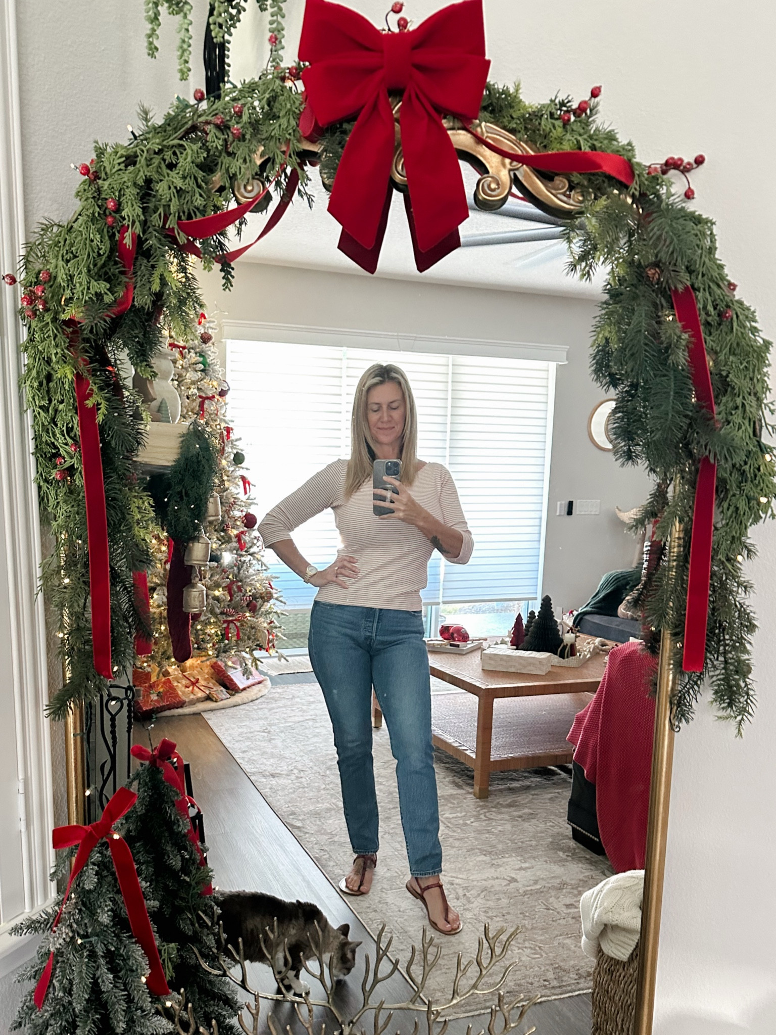 Decorating my mirror for Christmas has inspired me to take more selfies in the mirror normally not my fave way to share outfits love a good pic without the mirror but slowly getting better with these where do you look? lol linking some of the decor used on my mirror and my fave Levi’s #outfit #levis #jeans #mirrorselfies #mirrordecor #christmasdecor #garland #bows #christmaslights #stripedtee 

#LTKHoliday #LTKStyleTip #LTKGiftGuide
