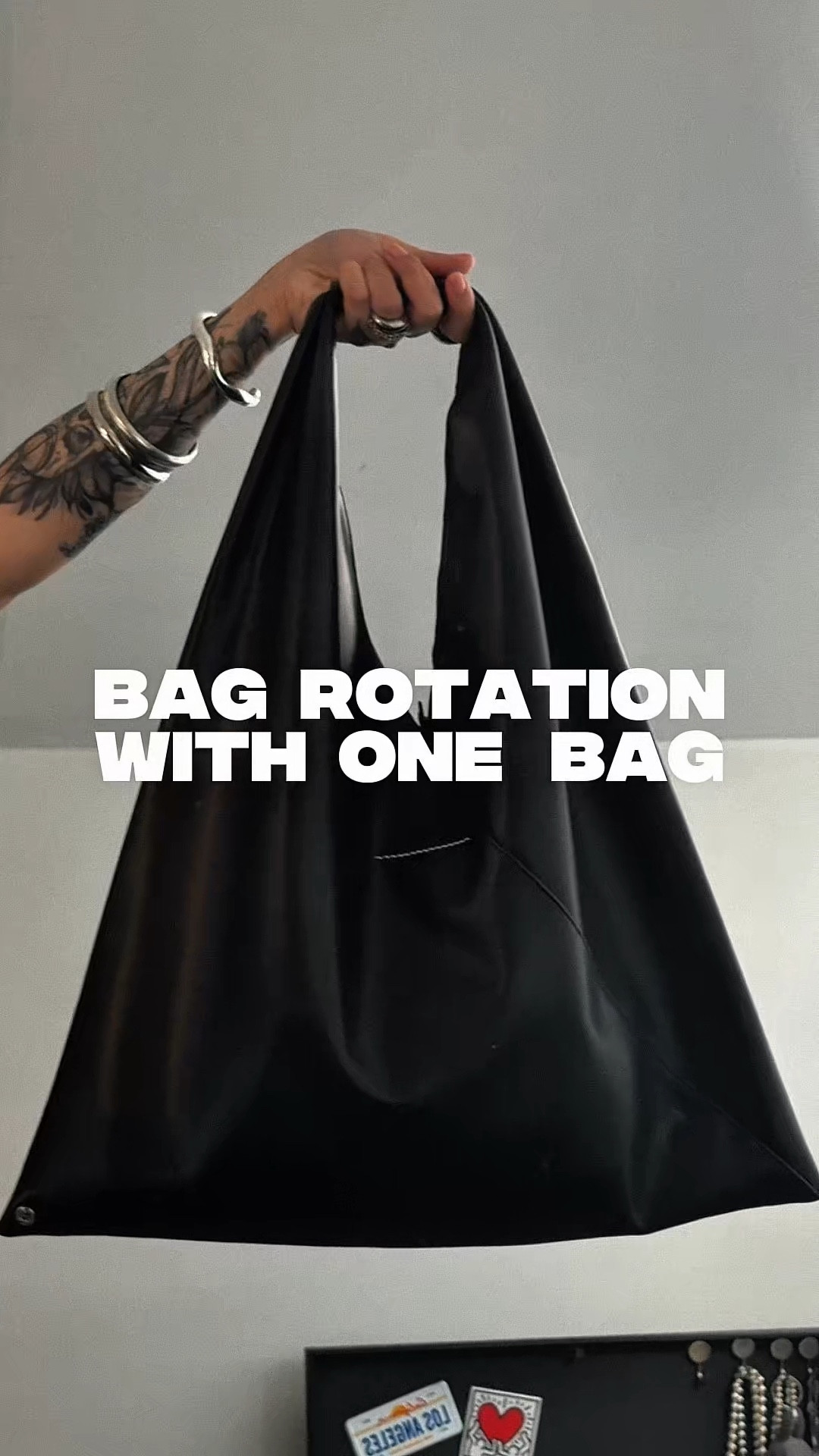 Maison Margiela MM6 triangle bag. A seemingly minimalist, simple black leather tote bag, but with an avant-garde twist. Transformed by adding just 2 buttons at either bag corners to connect, it becomes an origami bag where you can fold it in whatever way to form the bag you need for the occassion. This is 3 of my favourite folds out of 5 that I’ve discovered so far. This bag can be a regular medium-large tote (fits a lot), an oversized clutch, or a shoulder bag among other folds. I love that this bag is simple, yet an avant-garde art piece that you can interact with. 

I wore a light/medium wash barrel jean (hits right below the ankles, 5’7, size US 6), soft and comfortable, with a thoughtfully designed flowy, loose satin effect tube/bandeau top that has a hidden inner bandeau, and corset-like hook and eyes fore extra security from slipping (size large, 36C chest). 

#designerbagsale #holidaysale #casualoutfit #workbag #leathertotebag #mediumblackbags #largetote #everydaybag #dailybag #favouritebag  

#LTKootd #LTKSaleAlert #LTKMidsize