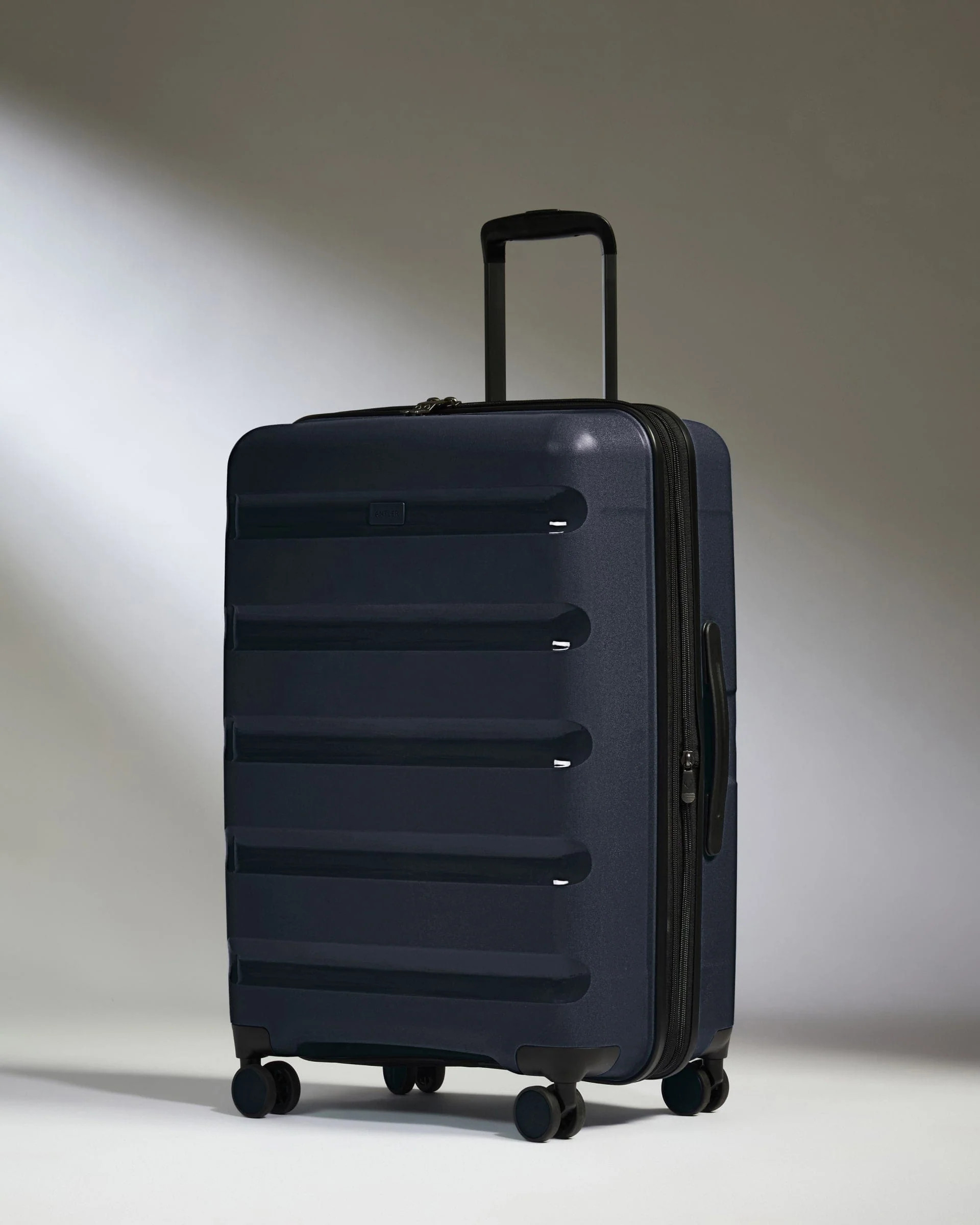 Medium Suitcase Navy - Logo Stripe | Lightweight Hard Shell Luggage | Antler UK