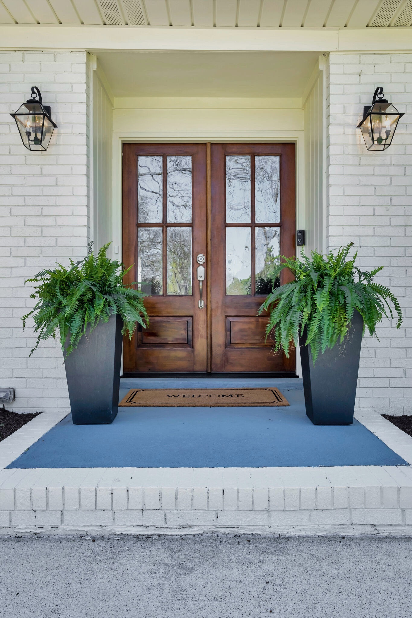 Warm & Inviting tall black planters with ferns & welcome mat. #planters #welcomemat #outdoorspaces #frontporch #frontporchstyle #summerporch #targetfinds #homedepot

#LTKFindsUnder100 #LTKHome