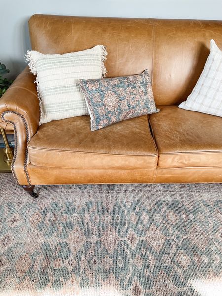 Leather sofa, patterned mix and match pillows, vintage inspired patterned rug

#LTKhome #LTKstyletip #LTKSeasonal