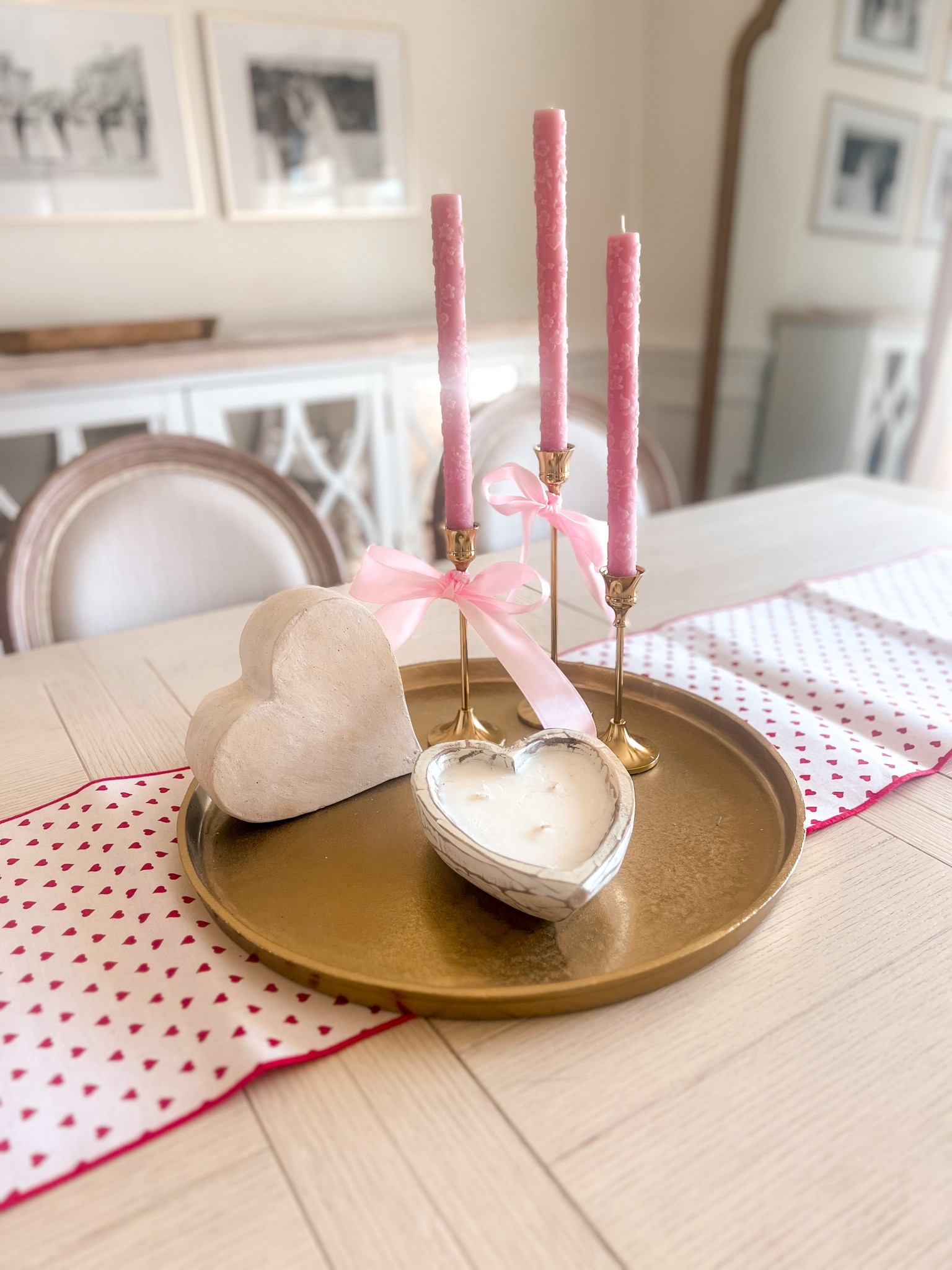 Valentine’s day centerpiece 
Heart shaped candle 
Pink candles
Gold tray
Pink ribbon
Heart print table runner 
Gold candle holders 