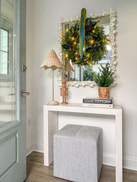 Our entryway was the first spot in our new home I decorated for Christmas! These holiday pieces were made for this spot. From the mixed evergreen pre-lit wreath, to the scalloped rattan lamps, to the potted tree, nutcracker and coffee table books! They look perfect with our white coral mirror, light wood console table, and striped ottoman cube. 
.
#liketkit #ltkholiday #ltkhome #ltkseasonal #ltkunder50 #ltkunder100 #ltkgiftguide #ltksalealert entryway decor, small console table, coastal decor, Christmas foyer


#LTKsalealert #LTKHoliday #LTKhome