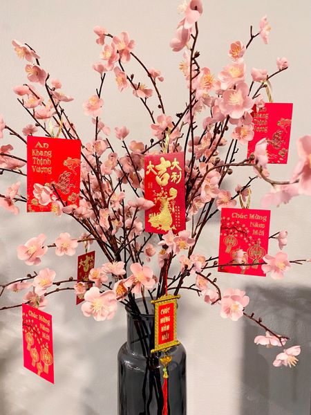 My pink cherry blossom stems are adorned with Vietnamese li xi red envelopes to welcome the Year of the Cat (Vietnamese)/Year of the Rabbit (Chinese)!!!

Linking some fun Lunar New Year decorations! These Tết decorations range from banners and signs to faux floral stems to silk lanterns!

#LTKhome #LTKunder100 #LTKunder50