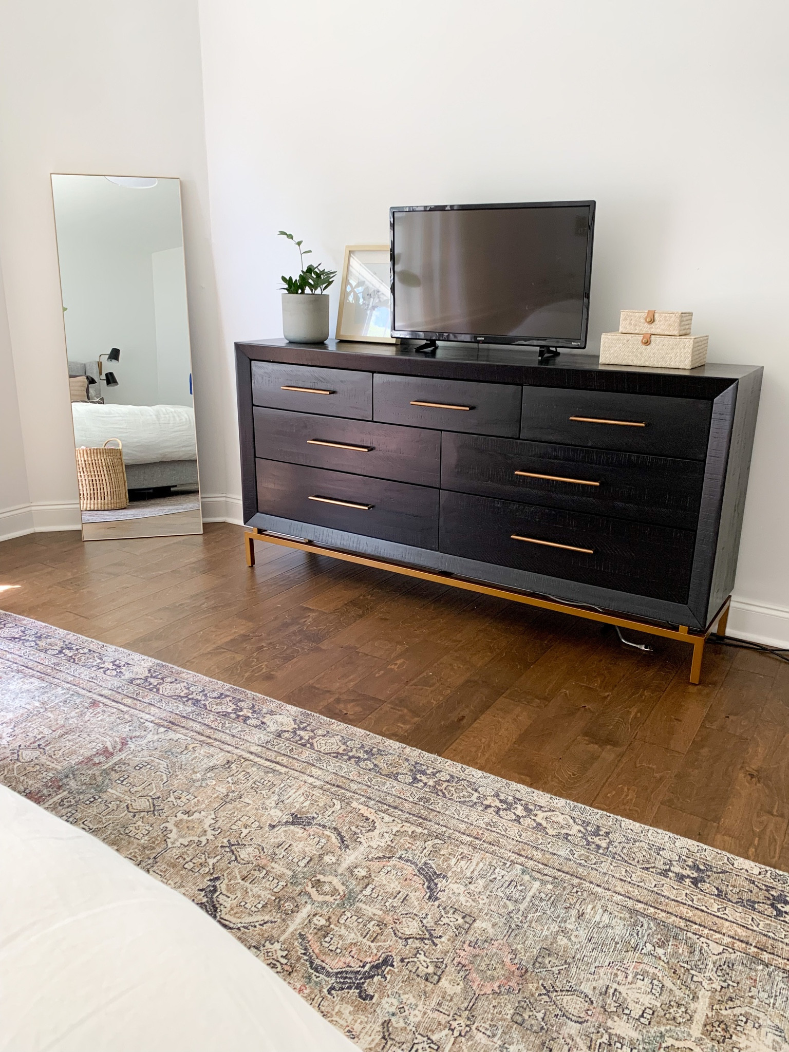 Our modern black dresser with gold hardware in our primary bedroom. Love that this dresser is solid wood! We had a hard time finding one and this has been perfect. 

#LTKFind #LTKhome #LTKSeasonal