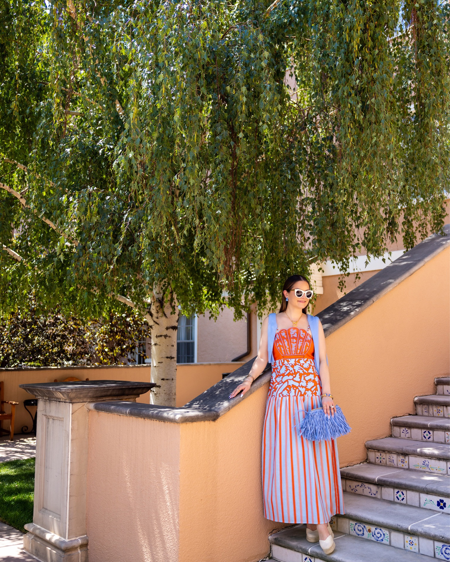 A gorgeous blue and tomato red printed midi column dress paired with a light blue sweater and fringe clutch bag at The Broadmoor in Colorado Springs

#LTKootd #LTKSaleAlert #LTKOver40