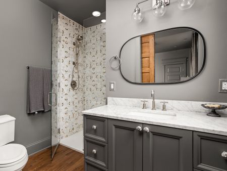 This bathroom completed the gray room, with mixed metals between the shower tile and fixtures .

#LTKhome