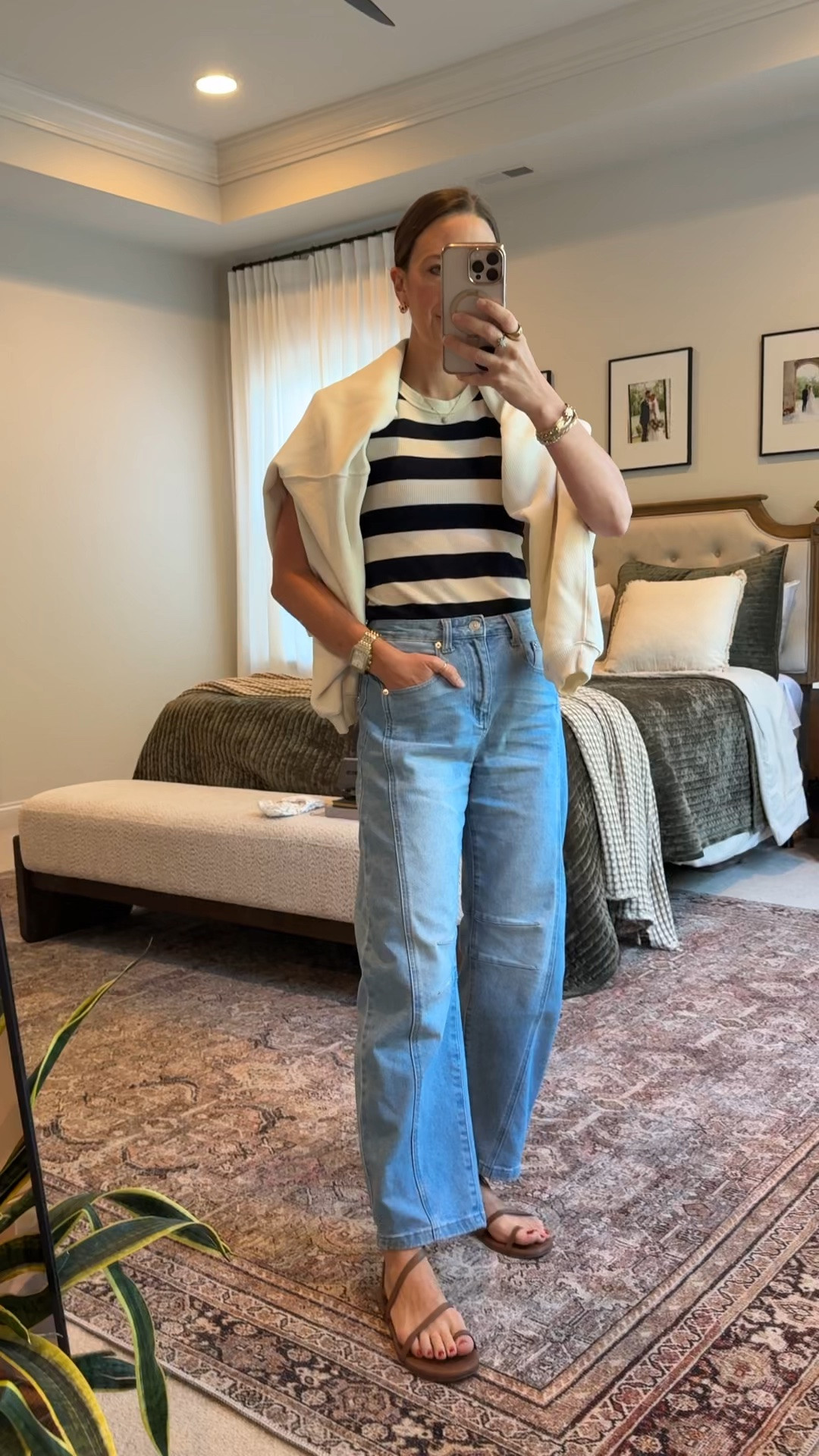 Casual spring capsule outfit: light-wash Amazon barrel jeans + a black & white striped tee, finished with a sweater draped over the shoulders and simple neutral sandals. Easy “put together” mom look for errands, school drop-off, or a casual workday. 🤍🖤 #barreljeans #capsulewardrobe #springoutfit #coastalstyle

#LTKootd #LTKmomlife #LTKSeasonal
