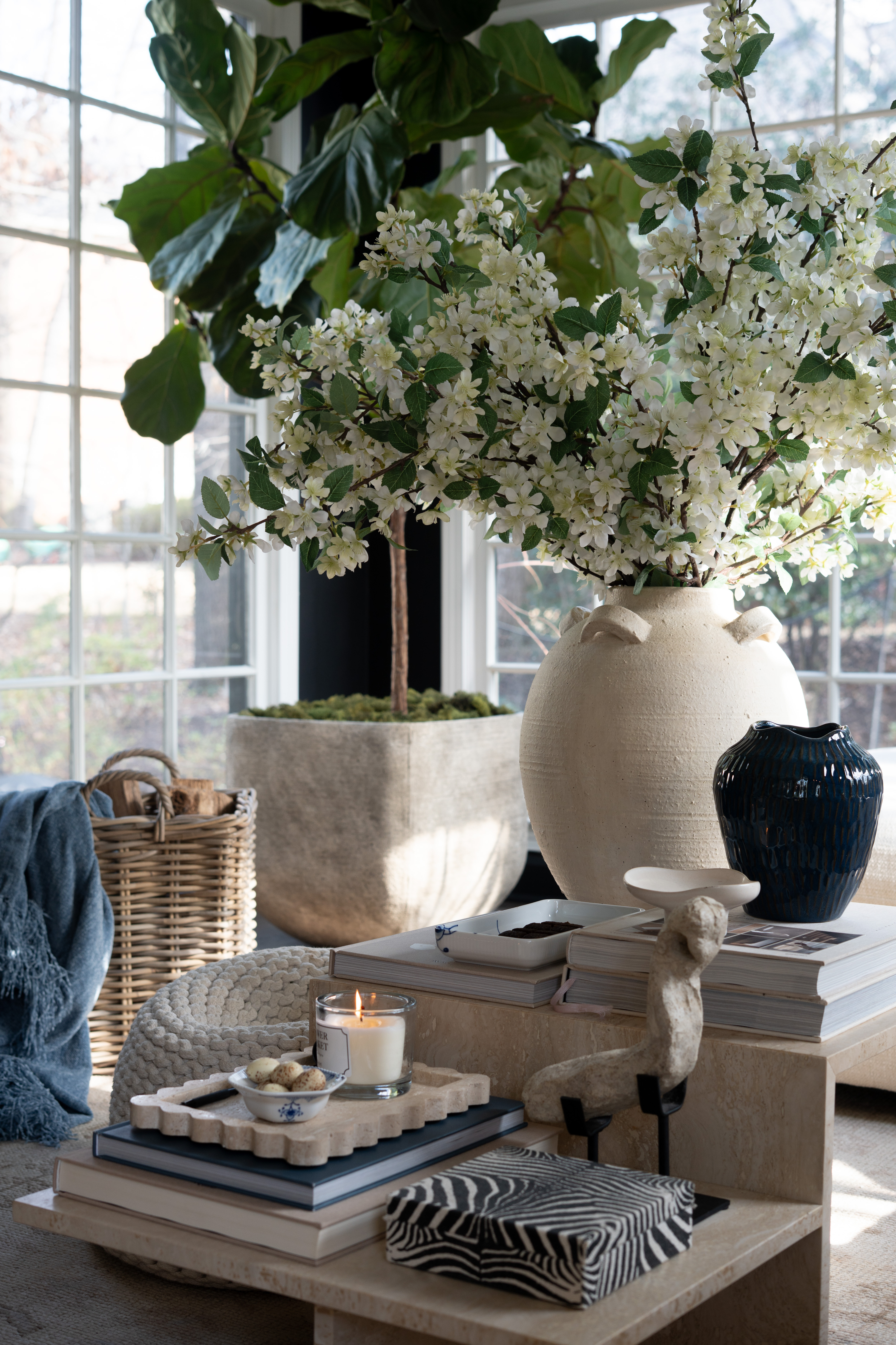 This is the kind of living room setup that makes you want to slow down for a while. The stunningflorals, marble coffee table styling, warm candle glow, and cozy textures create such a beautiful, peaceful space. 

 #LTKSpringSale #LTKSeasonal