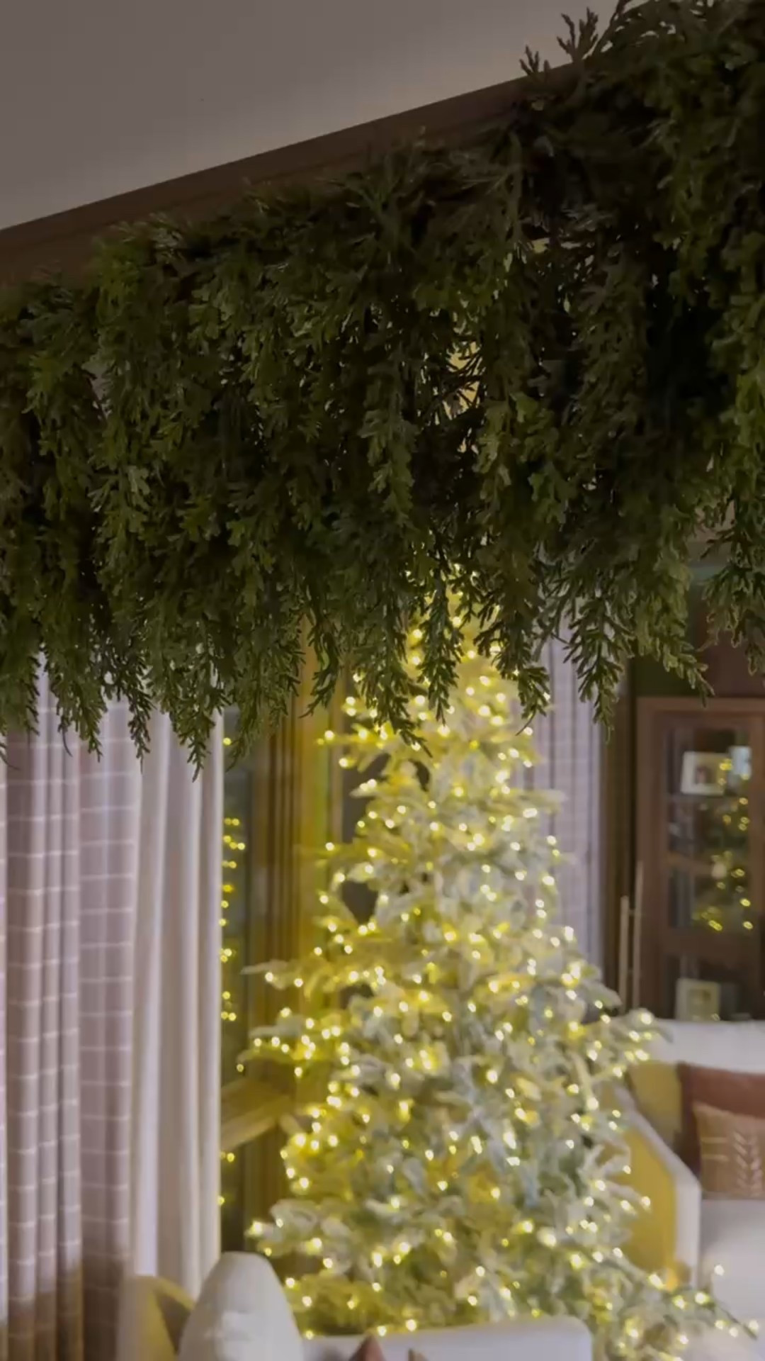 A garland-draped entrance leading to the dreamiest Christmas setup 🎄✨ Featuring our oversized cedar garland, the glowing King of Christmas flocked tree, soft cream swivel chairs, textured boho pillows, classic Persian-style rug, and the elegant marble-top accent table paired with a modern planter + faux greenery. Cozy, collected, and full of charm.

#holidaydecor #cozychristmas #flockedprelittree #garlanddecor #interiorstyling #livingroominspo #eanesinteriors



#LTKHoliday #LTKSeasonal #LTKHome