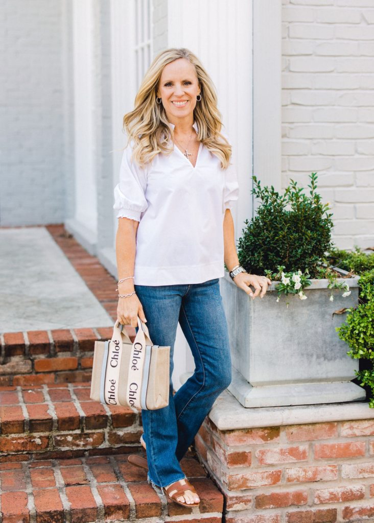 Classic go-to look for spring

White short sleeve top paired with bootcut jeans, brown leather sandals and a Chloé logo mini tote

#LTKFind #LTKSeasonal #LTKstyletip