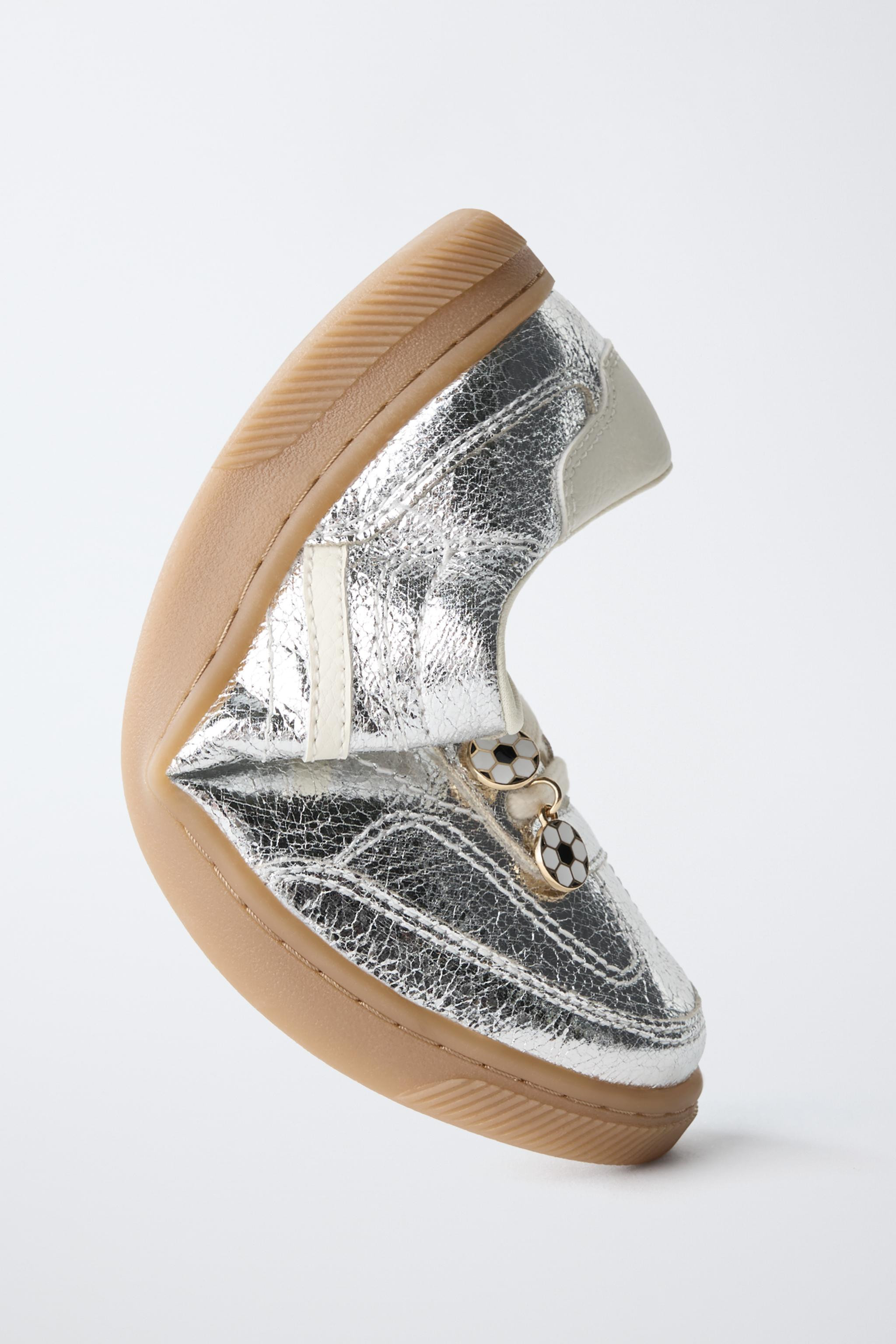 Sneakers with a metallic finish and adjustable decorative charms on the laces. Lace-up closure wi... | Zara US
