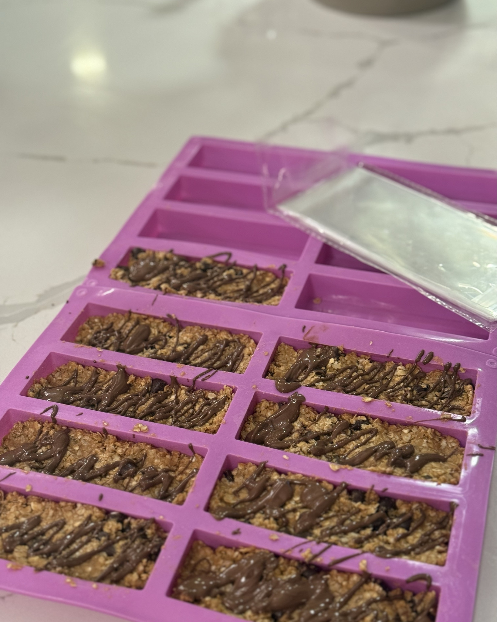 Update on the homemade granola bars…. My kids loved them. And now I grabbed this little silicone tray and these little baggies to make homemade granola bars easier! I’ll link them! Also, I’ll attach the recipe I use: 

2 cups rolled oats, 3/4 cup organic natural peanut butter (can sub for other nut butter), 1/4 cup honey, 1/8 cup maple syrup,  1/2 teaspoon vanilla extract, 1/4 teaspoon of salt, and dark chocolate chips. I also drizzle with dark chocolate but this is optional. Freeze for one hour. Pop them out and package in granola bar wrappers and leave in the refrigerator until you need them :) 

#LTKfoodie #LTKBaby #LTKKids