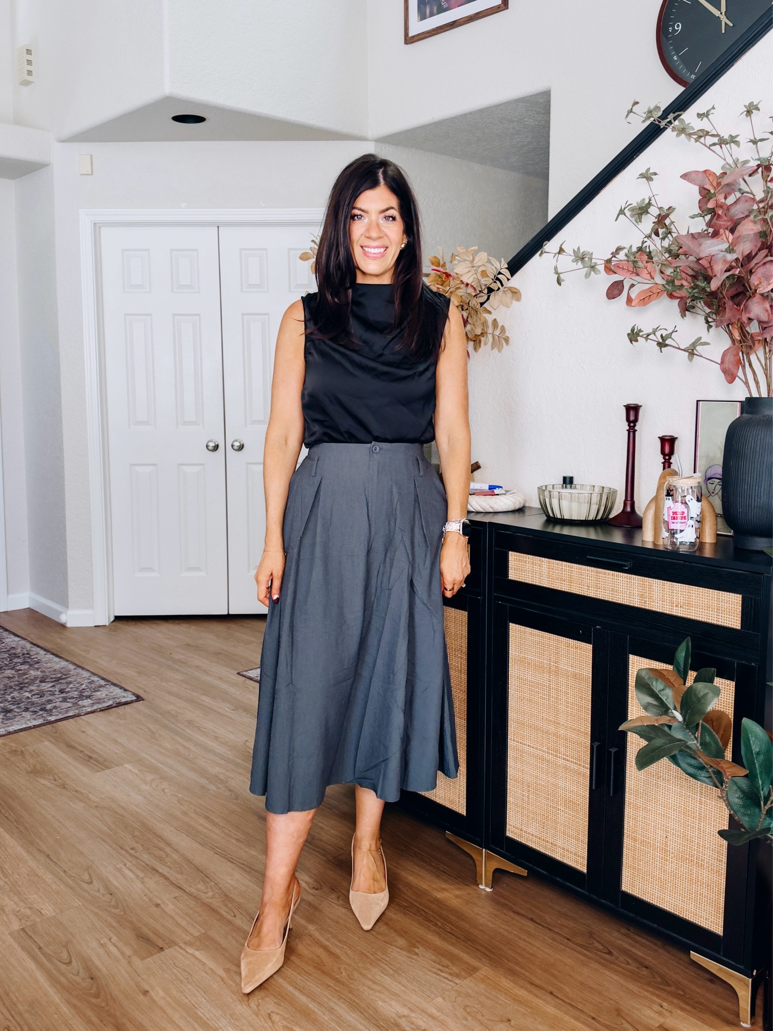 Workwear under $50
In a medium satin top and medium pleated skirt