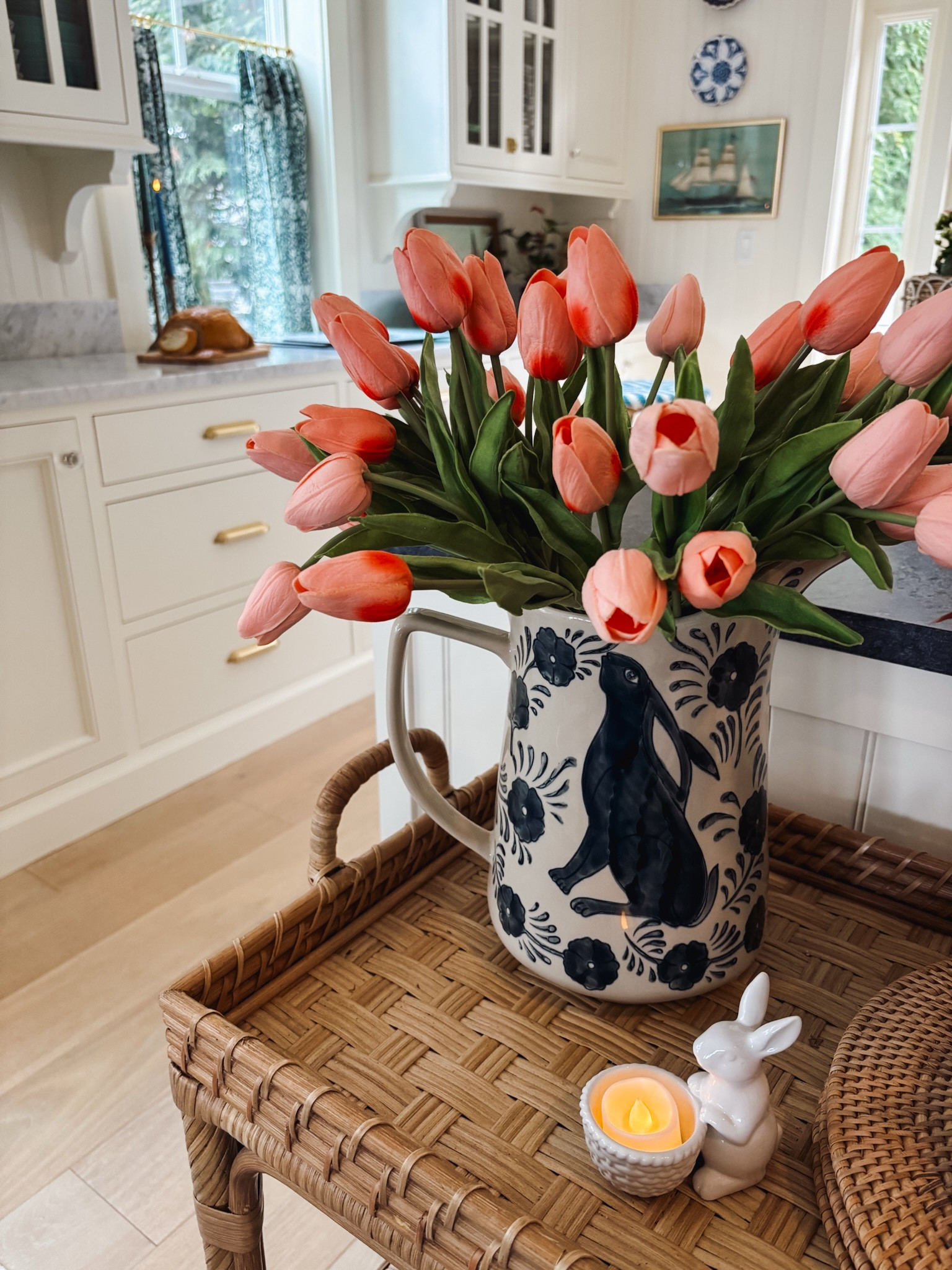 Bunny vase, favorite faux tulips (look and feel realistic!), bunny candy holder / tealight holder, rattan cart, blue and white plate on wall 

#LTKStyleTip #LTKSeasonal #LTKHome