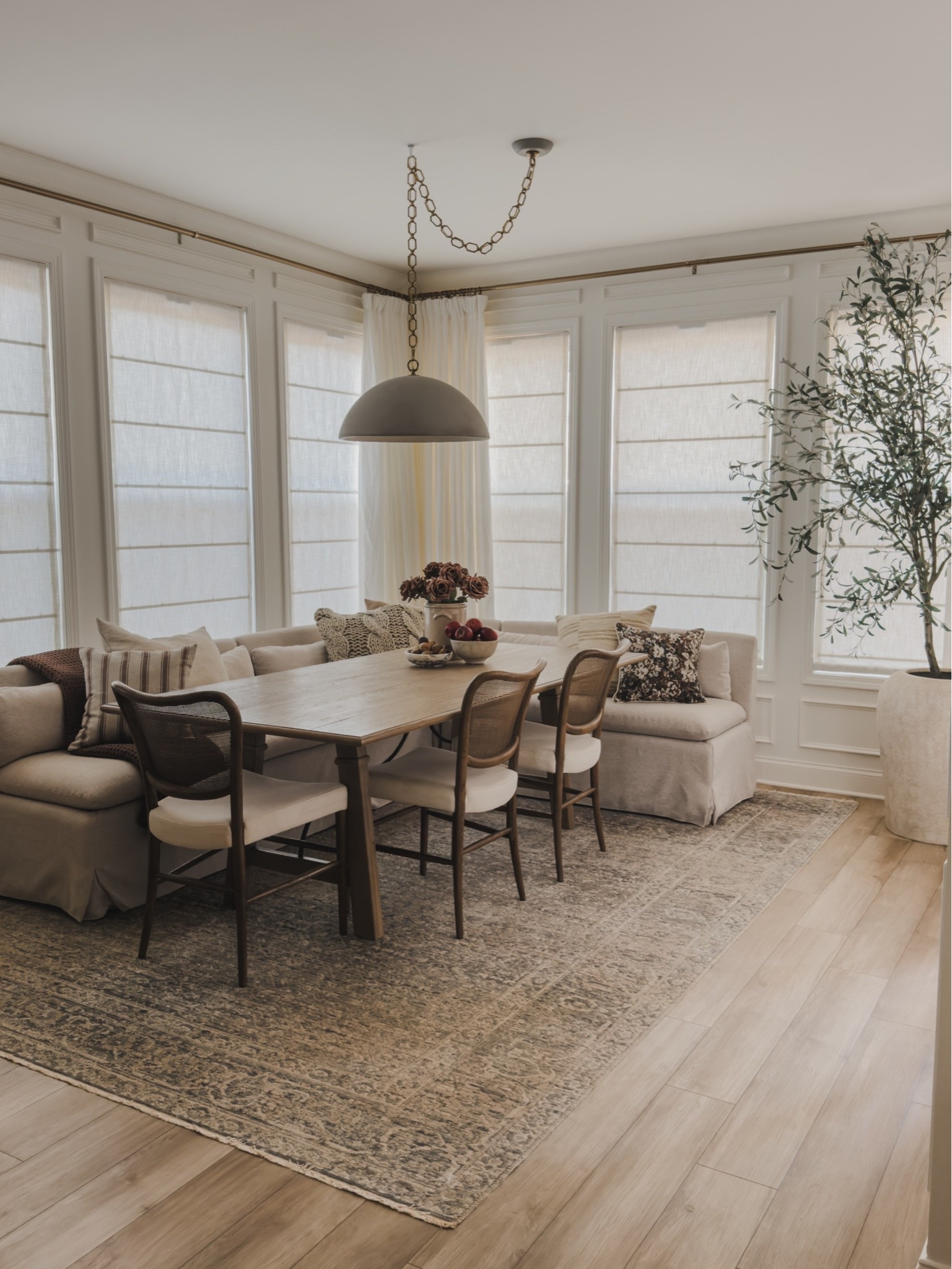 Cozy and timeless breakfast nook views! Loving small decor swaps each season for a functional yet aesthetic space through the year.

Home finds, neutral home inspo, collected style, breakfast nook refresh, fall refresh, neutral wood tones, furniture favorites, dining details, pendant lighting, linen curtain, linen Roman shades, dining chair, banquette details, vintage style area rug, cozy throw pillow, neutral throw blanket, faux olive tree, faux fall stems, found it on Amazon, Two Pages, Lumens, Pottery Barn style, Crate and Barrel, Arhaus, Loloi, Amber Lewis, Wayfair, shop the look!

#LTKSeasonal #LTKHome
