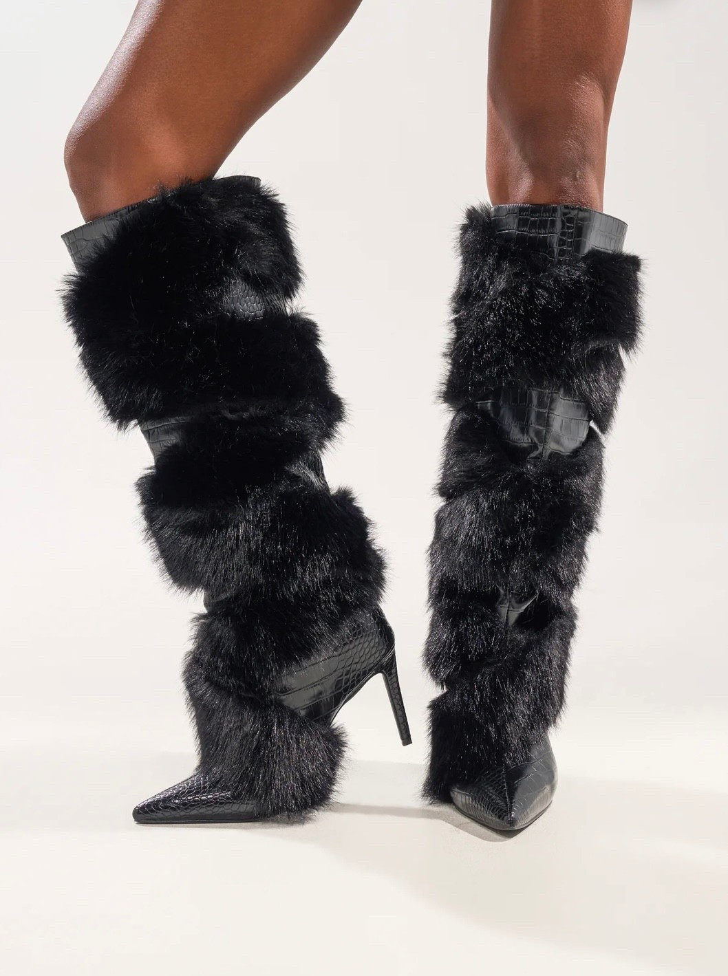 Black faux-fur knee high boots with a sleek stiletto heel and pointed toe. Luxe, bold, and made to turn heads.

#LTKootd
