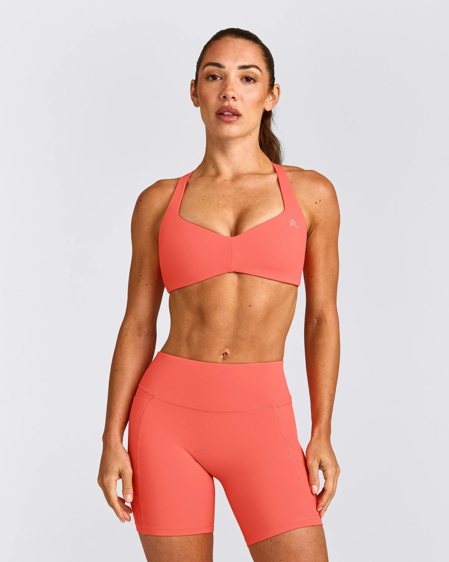 UnifiedMove\u2122 T Back Minimal Bralette with Reflective Logo 
 Light Charged Coral | Oner Active (UK / US)
