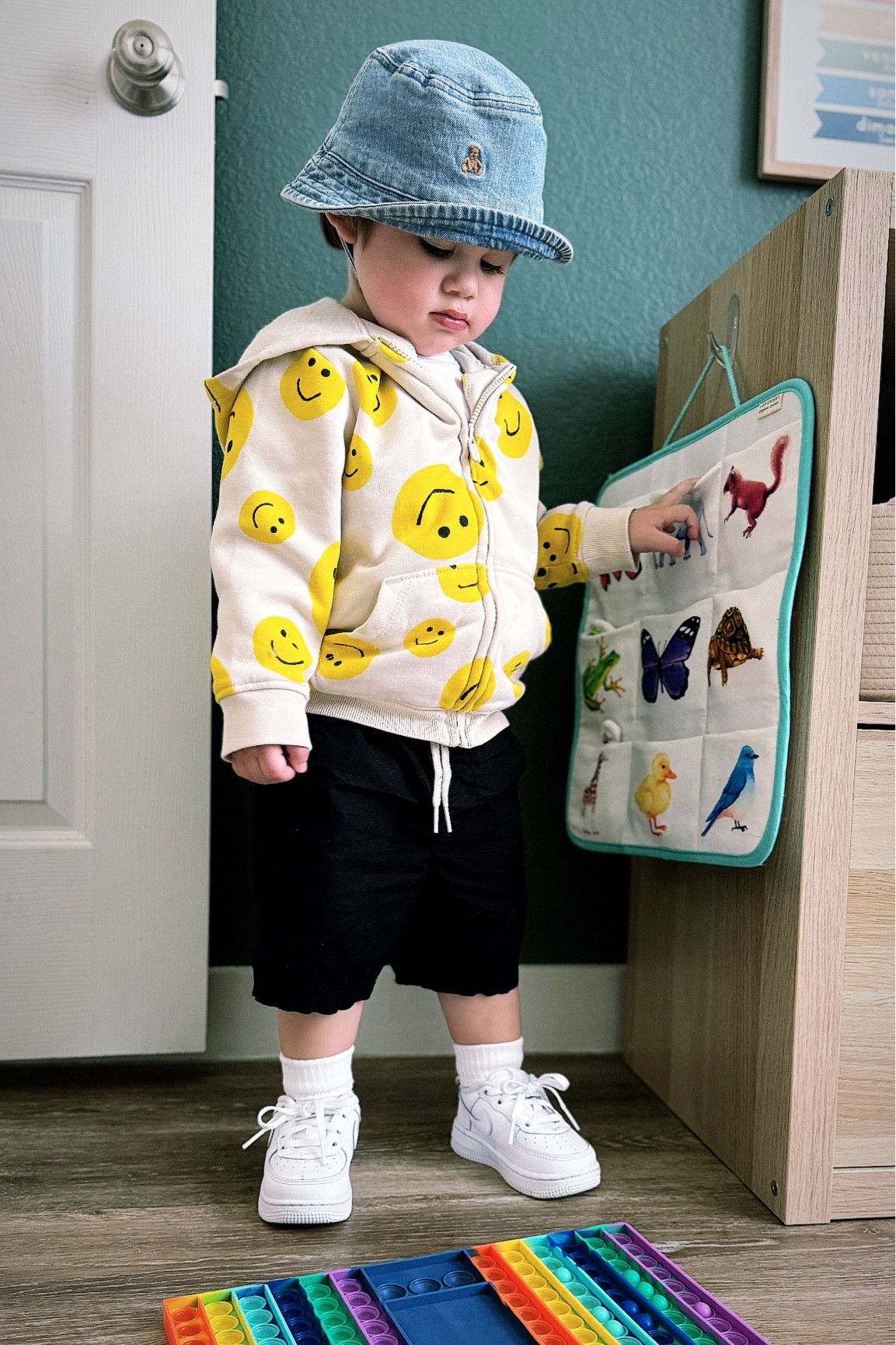 Toddler boy spring look 🙂 P is wearing a white tee from gap factory, black shorts from old navy, smiley face hoodie from old navy, denim bucket hat from gap factory, and white kids nike air force 1s from kids foot locker 

#LTKkids #LTKshoecrush #LTKSeasonal