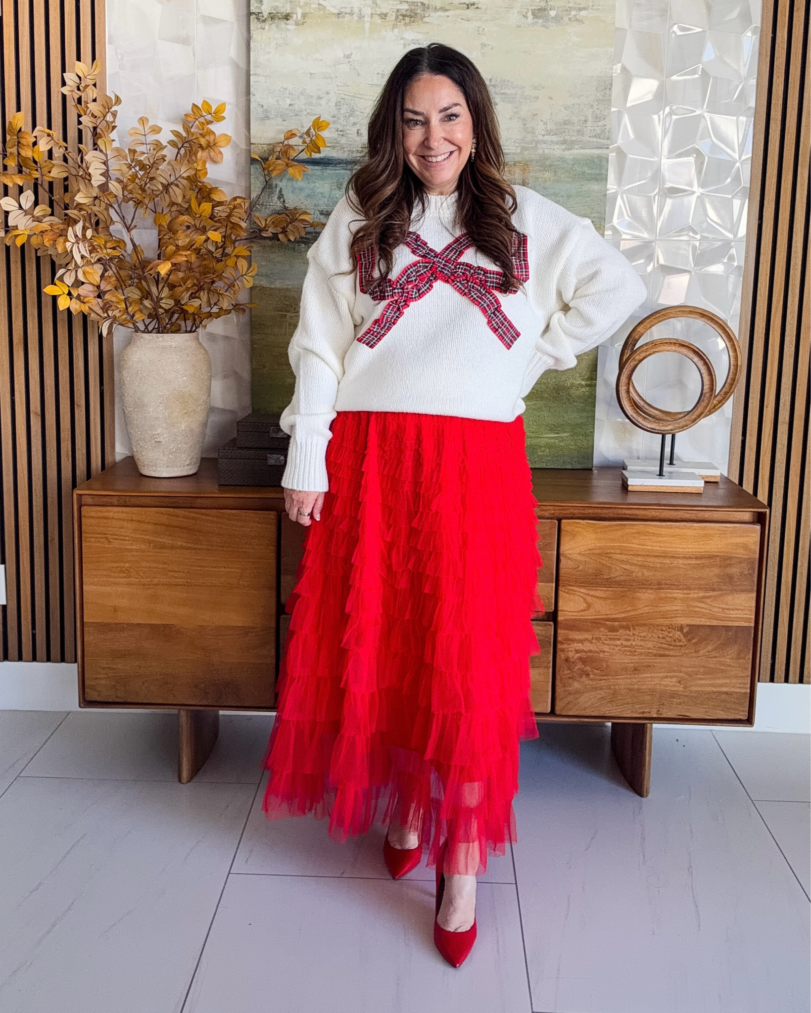 Bow sweater + red tiered tulle skirt ❤️ The most fun holiday party outfit! I love how the tulle twirls and red pumps make it extra festive 🎀

Sizing: Sweater, L | Skirt, L