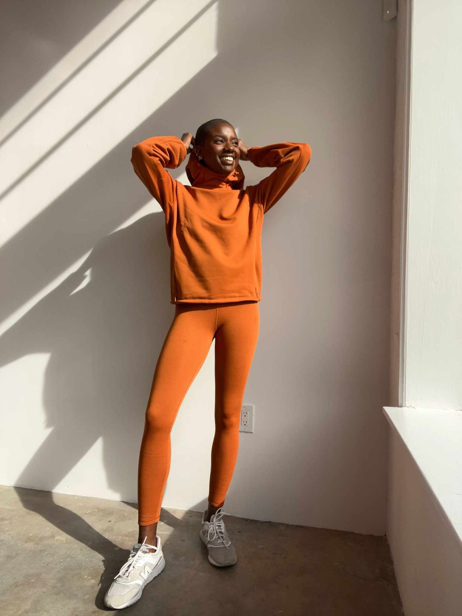 Rust orange fleece lined high rise leggings, rust orange fleece lined hoodie with front pocket, and white and grey retro new balance sneakers  

#LTKfindsunder100 #LTKfitness #LTKHoliday