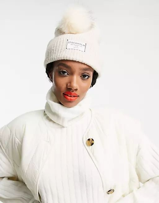 ASOS DESIGN rib knit pom beanie with label detail in cream | ASOS (Global)