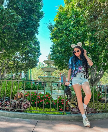 Loving this button up shirt from the Disney 100 vintage collection! It’s light and breathable and perfect for the hot temps here at the Disneyland parks! I paired it with cutoff denim shorts, but can easily be styled with mom jeans for winter months!✨💜 #Disney100 #DisneyOutfits #DisneyOOTD #DisneyOutfitInspo 

#LTKSeasonal #LTKunder50 #LTKstyletip