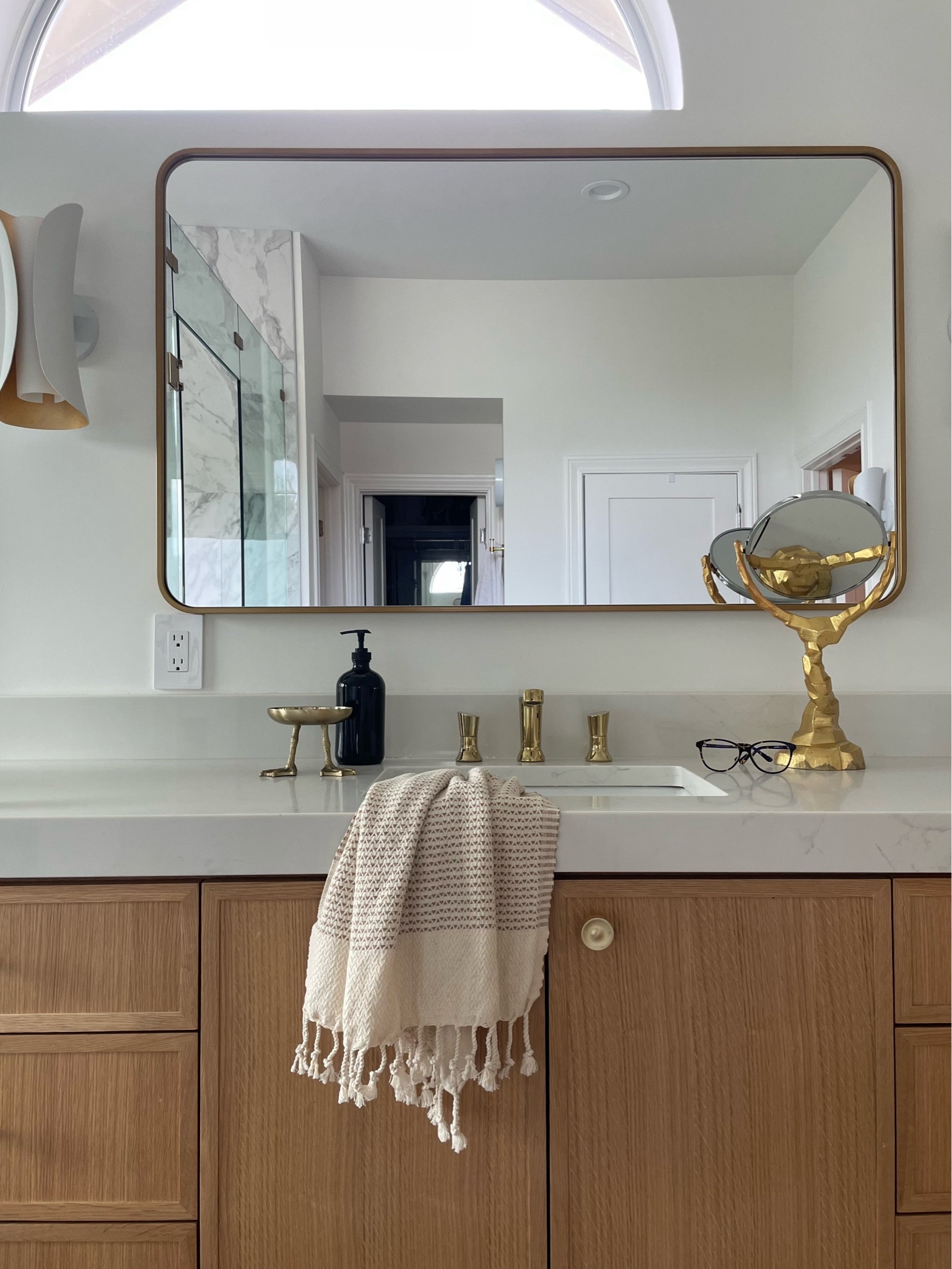 Warm bathroom vibes with brass accents 