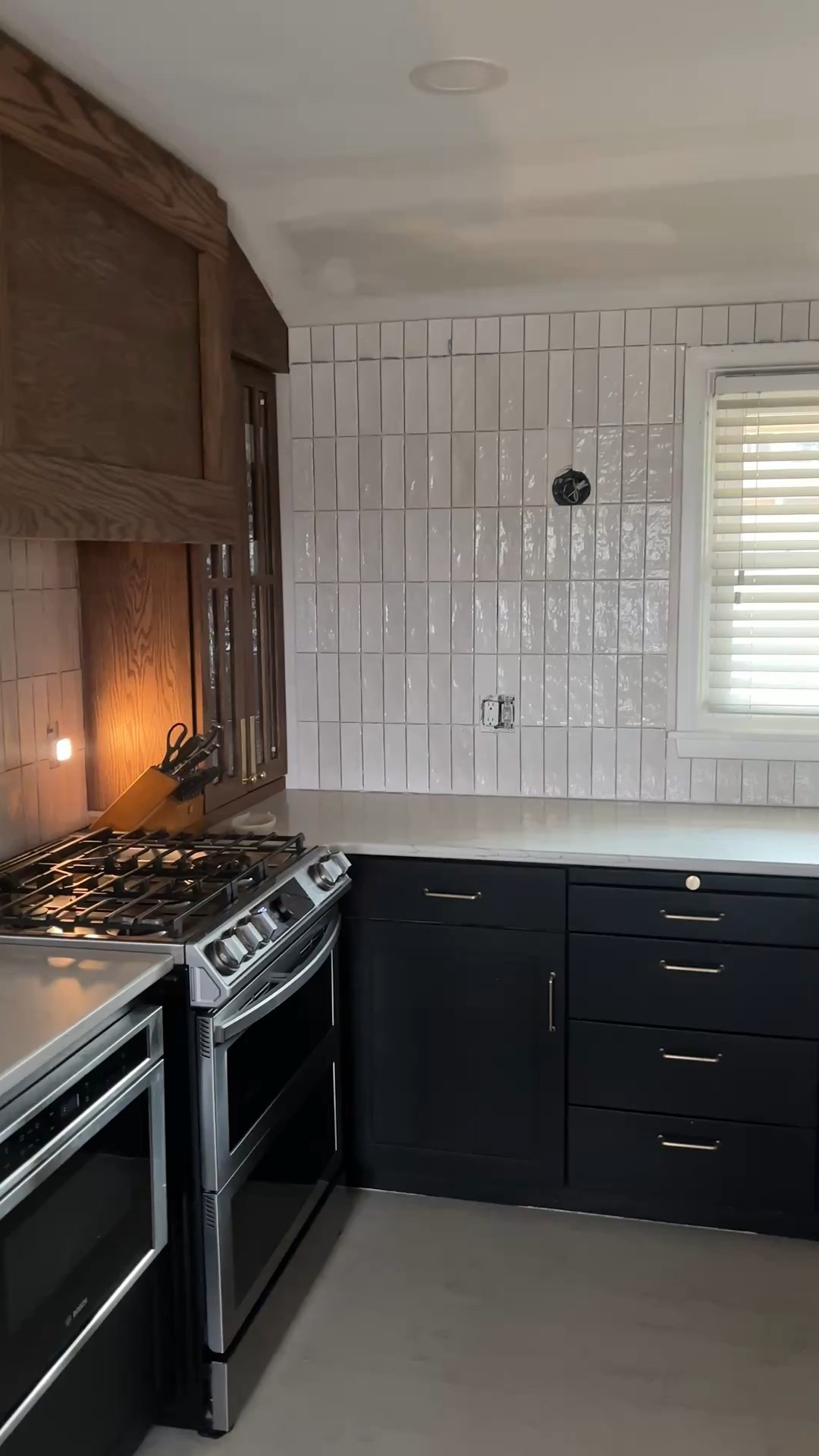 New backsplash is up! Still need to grout, install sconces, and figure out what to do with the ceiling (a beam perhaps?) 