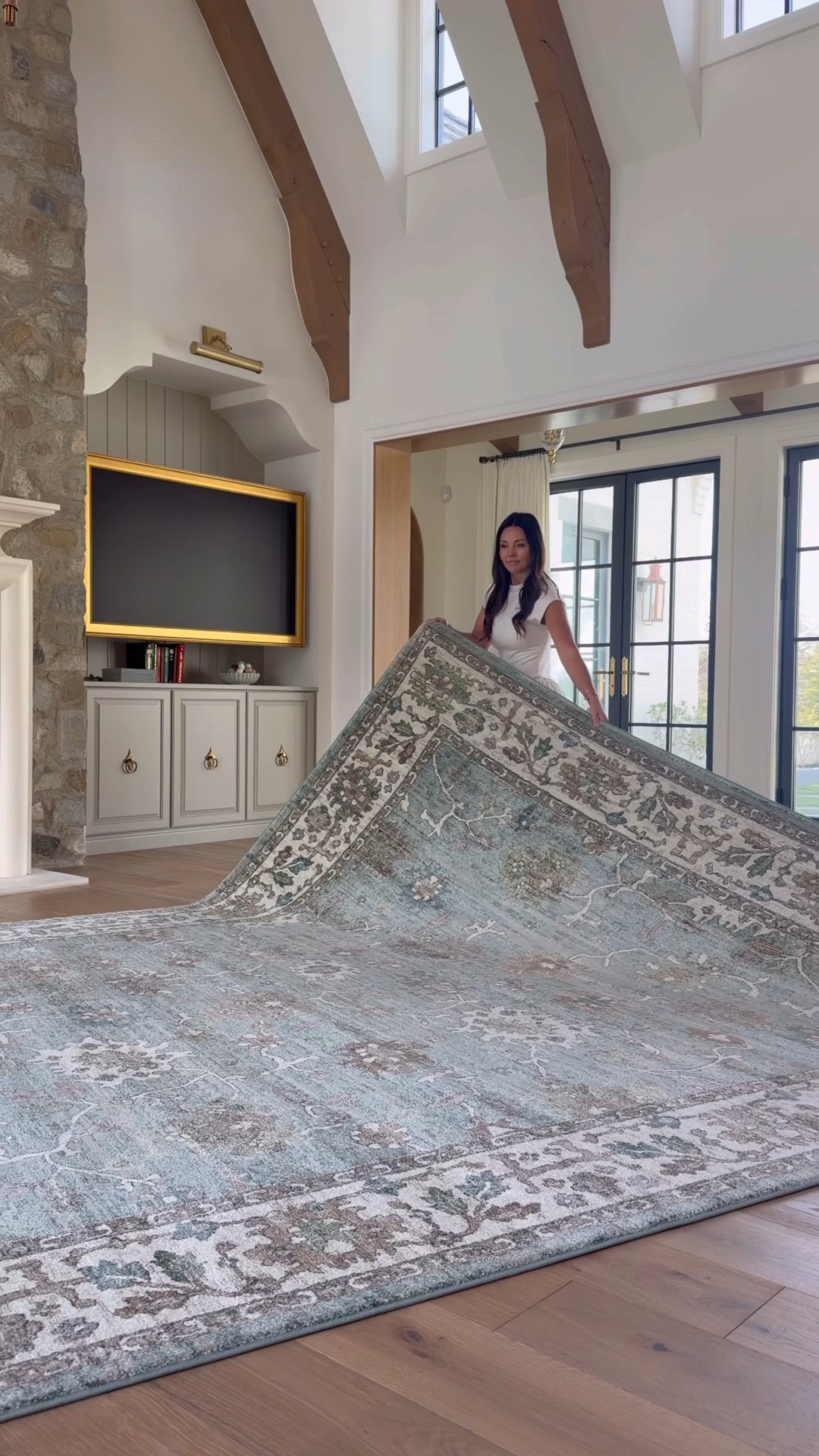 Traditional French style living room with blue rug, chenille sofas, leather swivel chairs, and turned leg coffee table. 

#LTKHome #LTKSaleAlert