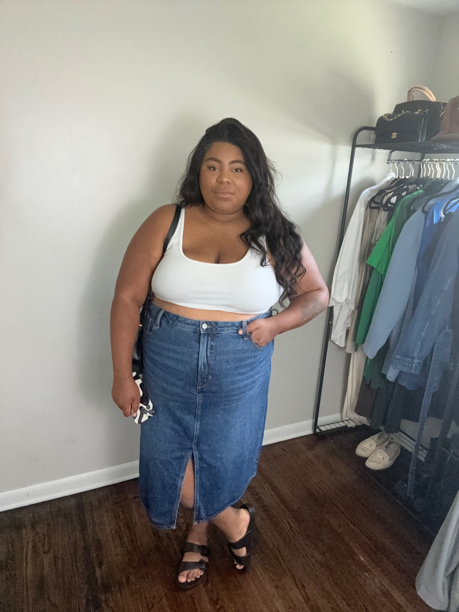 Plus size minimalist summer outfit of the day - denim skirt, white tank, black sandals, and black bag 

#LTKmidsize #LTKplussize #LTKfindsunder50
