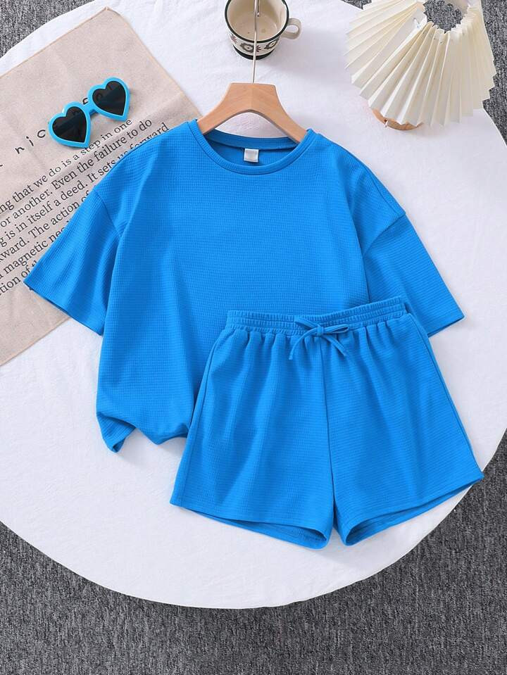 SHEIN 2pcs/Set Young Girl Solid Color Knitted Loose Round Neck T-Shirt & Form-Fitting Shorts | SHEIN