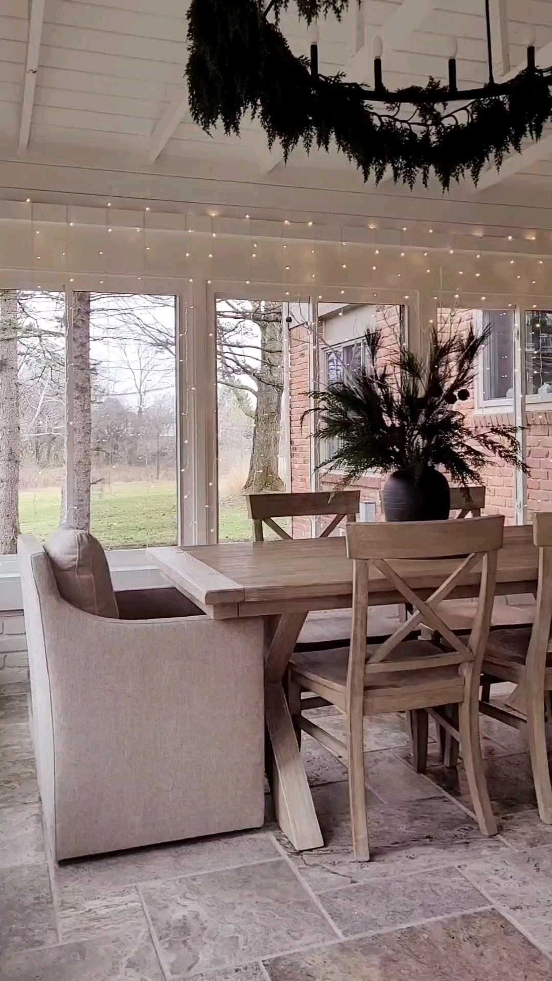 Simple holiday dining room with curtain Christmas lights,  designer inspired upholstered chairs,  and garland on the oversized chandelier!

#LTKWatchNow #LTKHoliday #LTKHome
