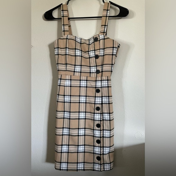H&M Divided overall dress Tan and white plaid mini dress with button detailing. | Poshmark