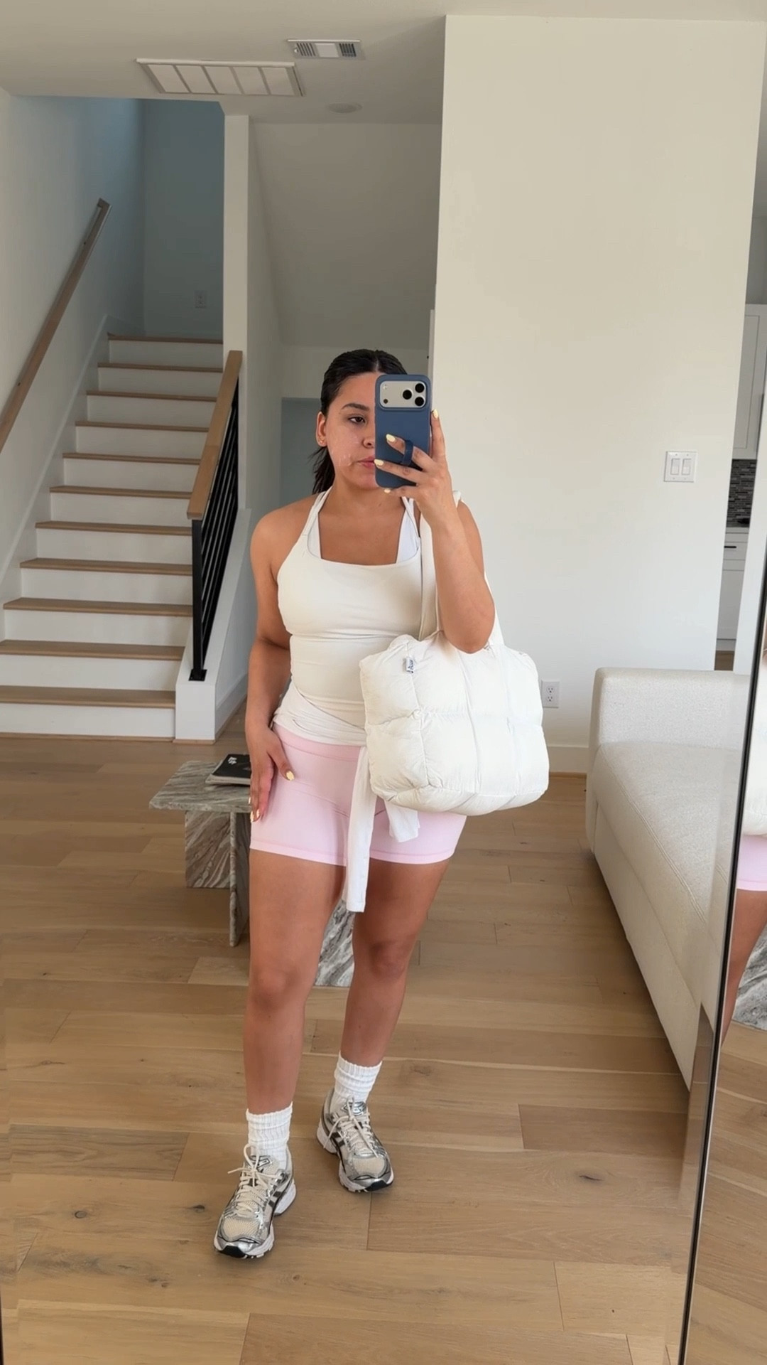 Tank: small
Sports bra: small
Shorts: 4 
Long sleeve: small
Sneakers: 6.5 women 
Pilates grip socks 
Puffer tote bag 