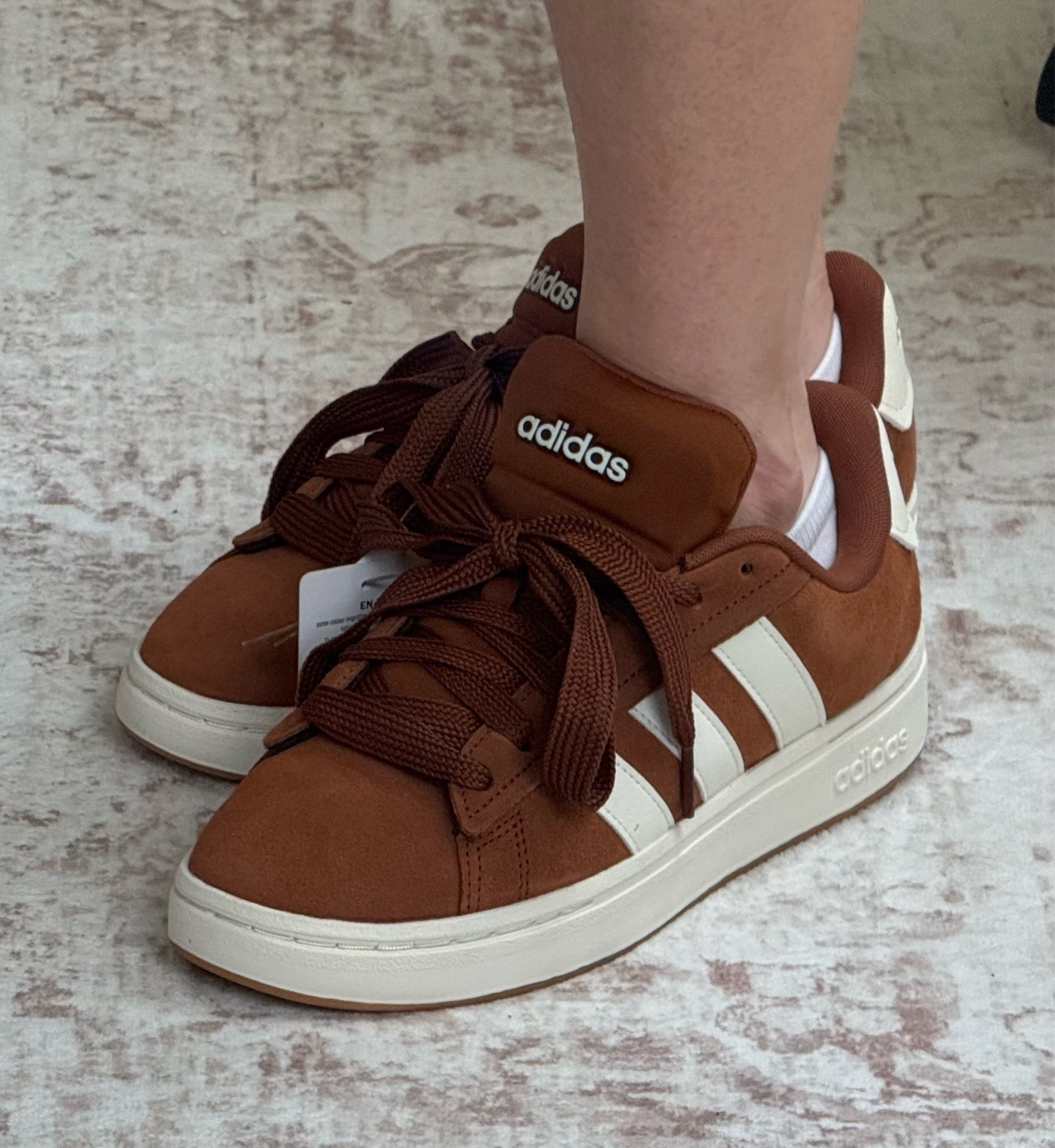 When you buy the same sneaker THREE times… you know it’s good. 👟🤎

These are hands down one of my favorite Adidas styles. They have that updated retro, ’90s-inspired look that’s everywhere right now, but with the comfort of a modern sneaker. They’re super cushy and seriously feel like you’re walking on a cloud.

And can we talk about this COLOR?! 🤎 It can be surprisingly hard to find sneakers in beautiful Autumn and Spring-friendly shades, and this warm cognac/rust is such a good crossover color for both palettes.

One thing I’m always careful about with sneakers is bulk. I have tiny ankles, and some chunkier styles can make my legs look like little toothpicks sticking out of my shoes. 😂 These have just enough substance without overwhelming my frame.

This is my THIRD pair in the Grand Court style, so that probably tells you everything you need to know. 🙌🏻 Comfortable, cute, on-trend and so easy to work into a warm-toned wardrobe.

#LTKShoeCrush #LTKStyleTip #AdidasStyle #AutumnStyle #SpringStyle #SneakerStyle

#LTKmomlife #LTKActive #LTKOver40