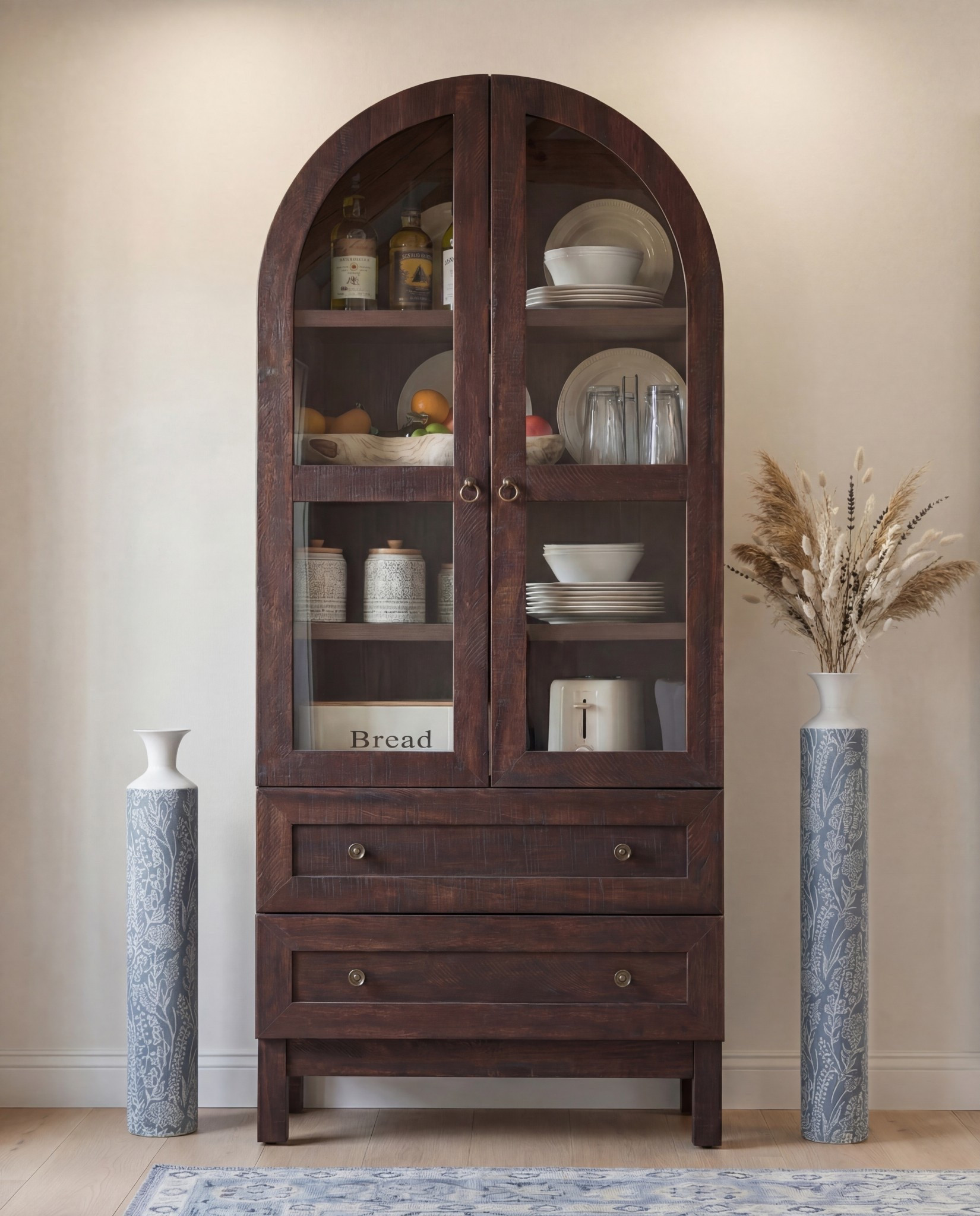 
Shop the Look:
• Dark wood rectangular dining table
• Curved ivory upholstered dining chairs (wood base)
• Blue ceramic decorative bowl (table centerpiece)
• Brass vase with dried branches
• Blue patterned area rug
• Light wood sideboard with fluted drawer detail
• Blue-and-white ceramic vase (sideboard)
• Neutral table lamp with white shade
• Stacked books + candle decor
• Framed landscape wall art (set of two)
• Dark wood arched china cabinet with glass doors
• White ceramic floor vase
• Exposed wood ceiling beams
• Soft blue ceiling paint
Tall blue floor vase 

#LTKSaleAlert #LTKHome #LTKFindsUnder100