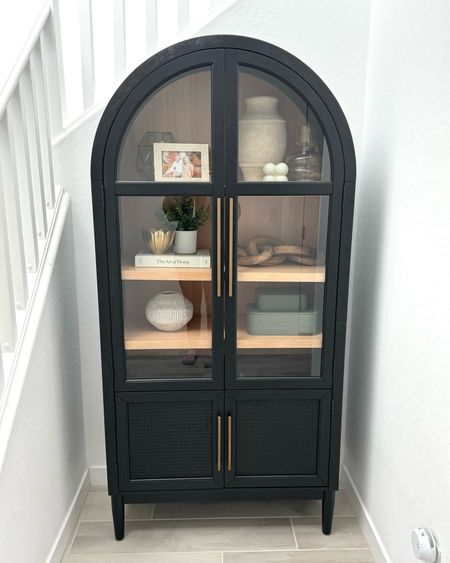 This black bookcase cabinet fits so perfect in this little nook by my stairs. I used to have a little console there but this completes the space. 

#LTKhome #LTKstyletip #LTKfindsunder50