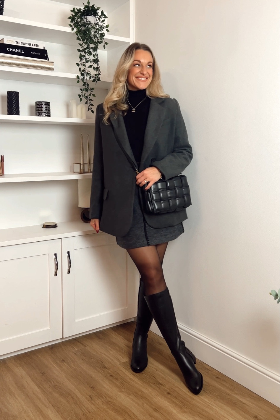 Black flat knee high leather boots, boiled wool grey skirt arket, 
Wool dark grey blazer, 20 denier tights , black leather padded handbag and black roll neck knitted jumper 

#LTKshoecrush #LTKHoliday #LTKmidsize
