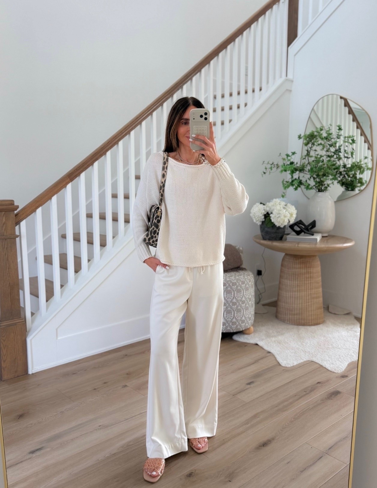 Bestseller! This is one of those outfits that feels dressed up while still being ridiculously comfortable. The lightweight knit with these flowy white pants gives effortless vacation energy, and I love the little leopard bag moment.

white pants, neutral outfit, lightweight sweater, vacation outfit, elevated casual style, spring outfit ideas, effortless style, chic everyday outfit, leopard bag, annabrstyle

#LTKootd #LTKSeasonal #LTKOver40
