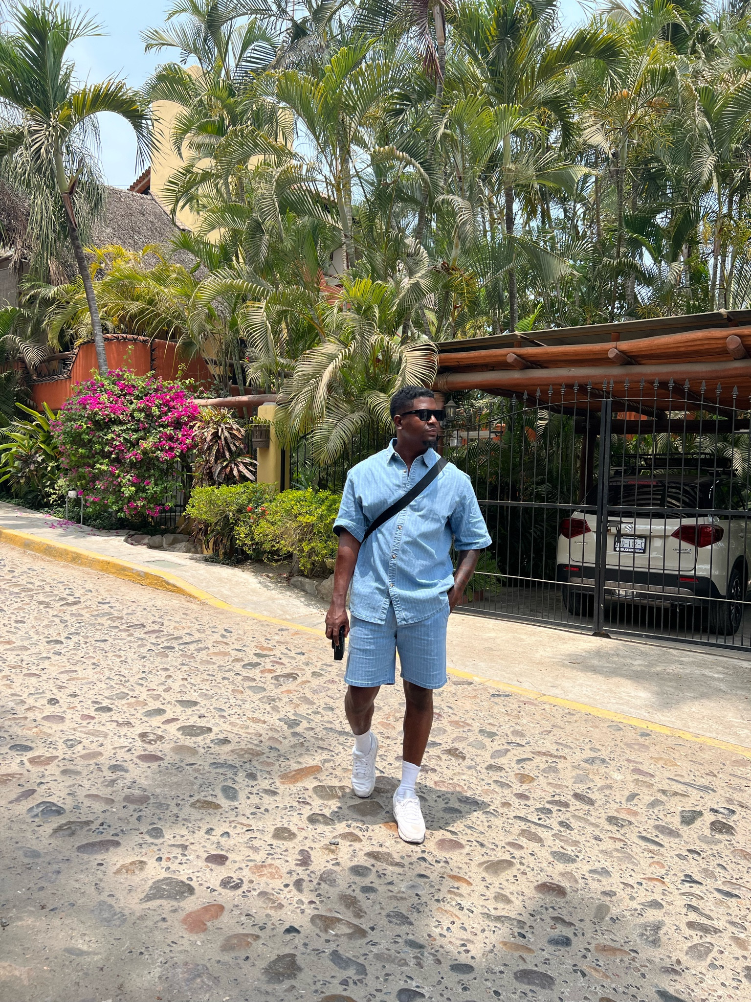 Matching blue Jean short denim set from Mango, paired with white sneakers and sunglasses 