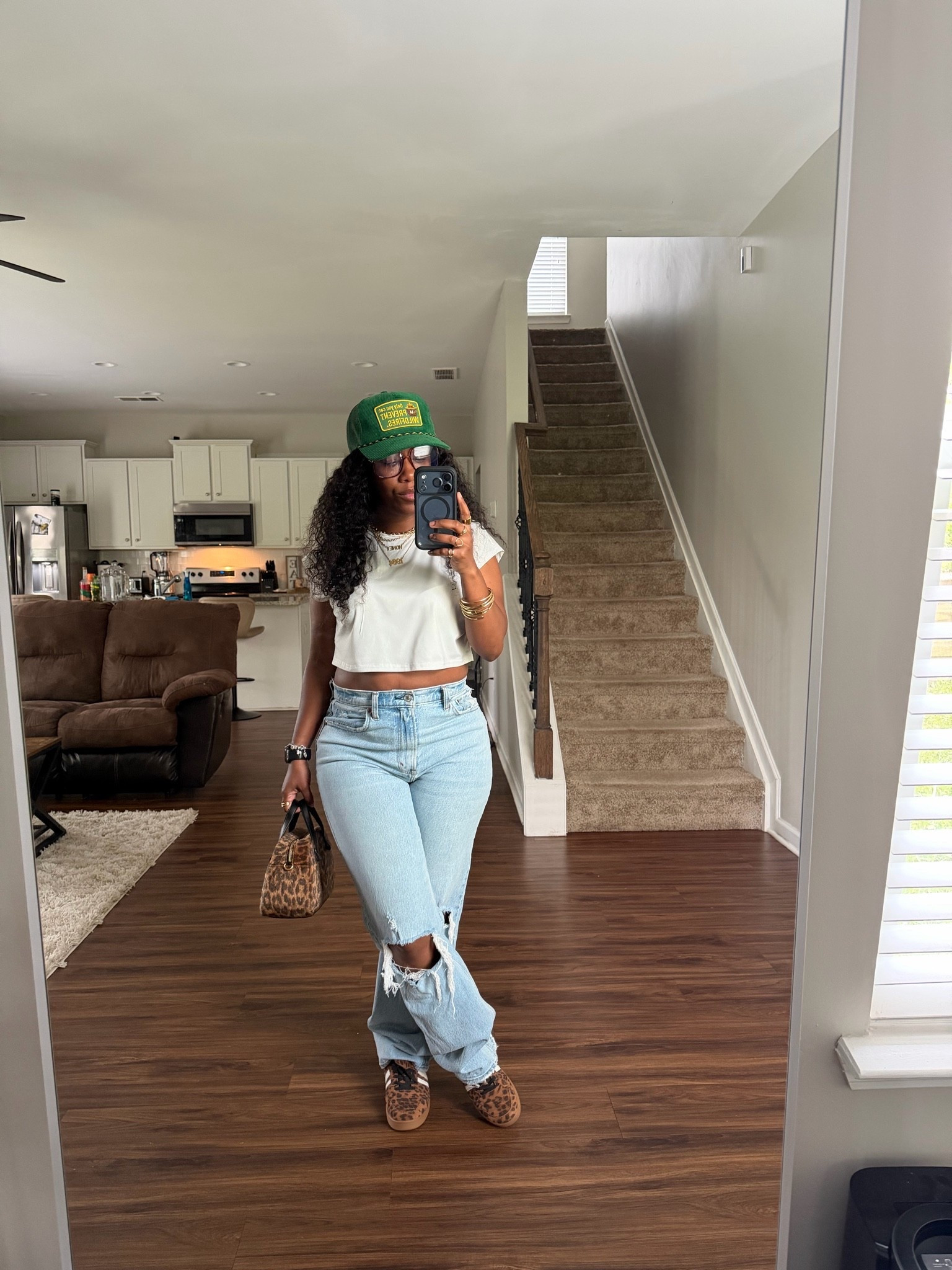 How to style high waisted jeans for the summer. I’m wearing a white sleeveless crop top, Abercrombie & Fitch jeans, green trucker hat, leopard print purse, and leopard print sneakers

#LTKootd #LTKOver40 #LTKPetite