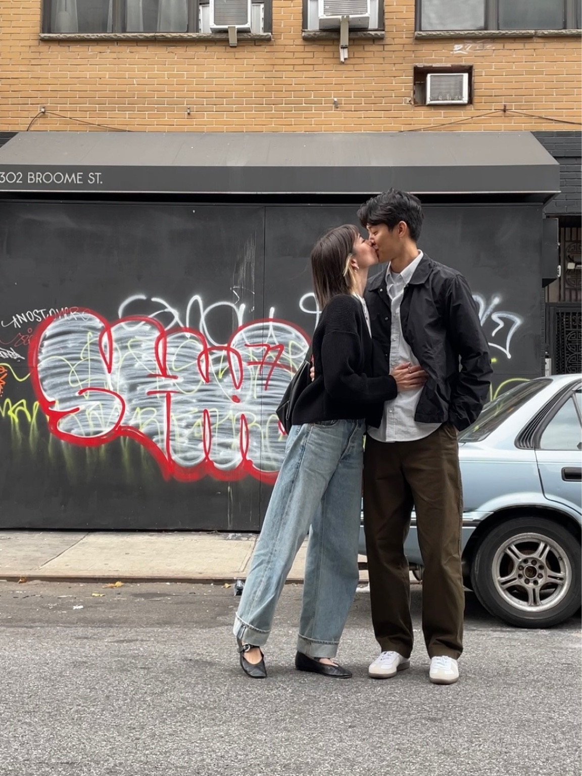 Anna
Sweater: Sea Room Lynn (JP brand)
Tee: reformation 
Jeans: citizens of humanity
Shoes: reformation 
Bag: from a shop in Japan, no link/brand name unfortunately 

Kevin
Pants: Uniqlo U
Shoes: adidas Gw Army
