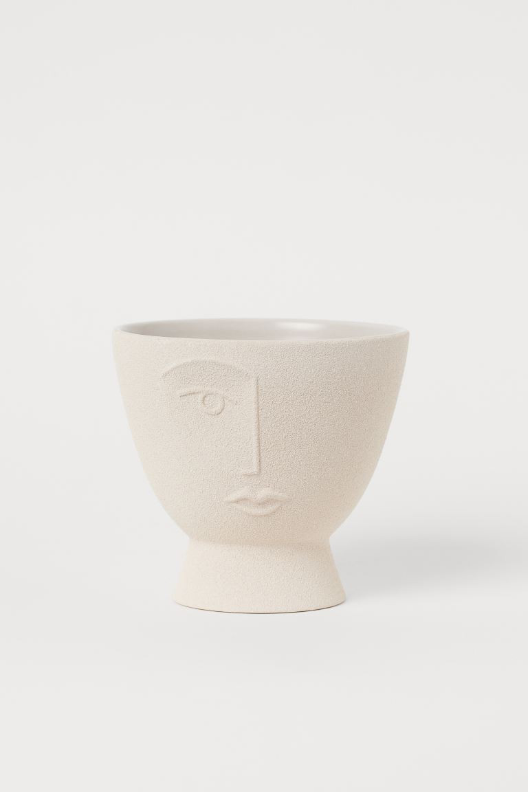 Ceramic plant pot with a face design and a small stem. Height 6 1/2 in. Diameter 7 in. | H&M (US + CA)