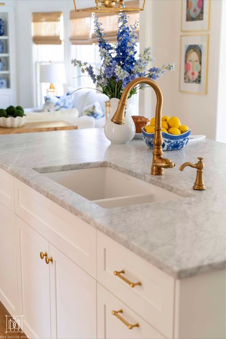 Classic kitchen with Carrera marble countertops and brass kitchen faucet
Unlacquered brass hardware knobs and pulls 


#LTKhome