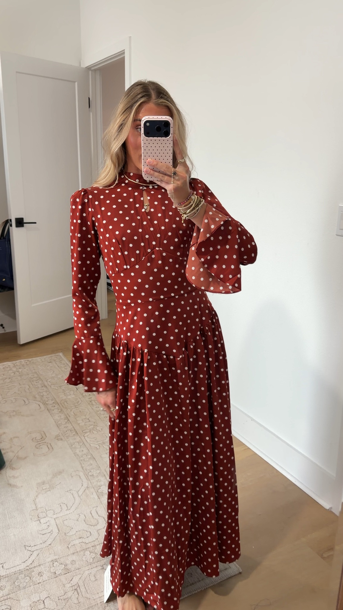 @Chicwish size xs-s Wrap yourself in timeless retro elegance with this classic polka dot dress—designed to blend vintage-inspired silhouettes with thoughtful figure-flattering details. It features a refined stand collar finished with a delicate front keyhole cutout for subtle allure, paired with elegant long bell sleeves that flare gently at the cuffs to add soft romantic movement. The fitted waist is enhanced by an adjustable lace-up corset detail at the back, allowing you to customize the fit to cinch your silhouette perfectly, while a discreet concealed back zip closure delivers easy on-and-off wear. Voluminous gathered tiers flow from the defined waist down to the maxi-length hem, creating lightweight floating movement with every step.